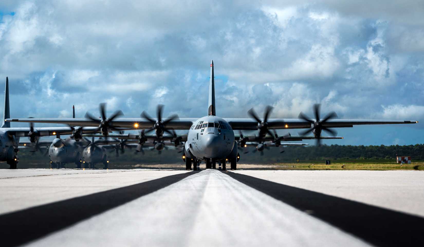 A formation of C-130J Super Hercules and C-130H Hercules aircraft from the U.S., Japan and Republic of Korea air forces taxi.