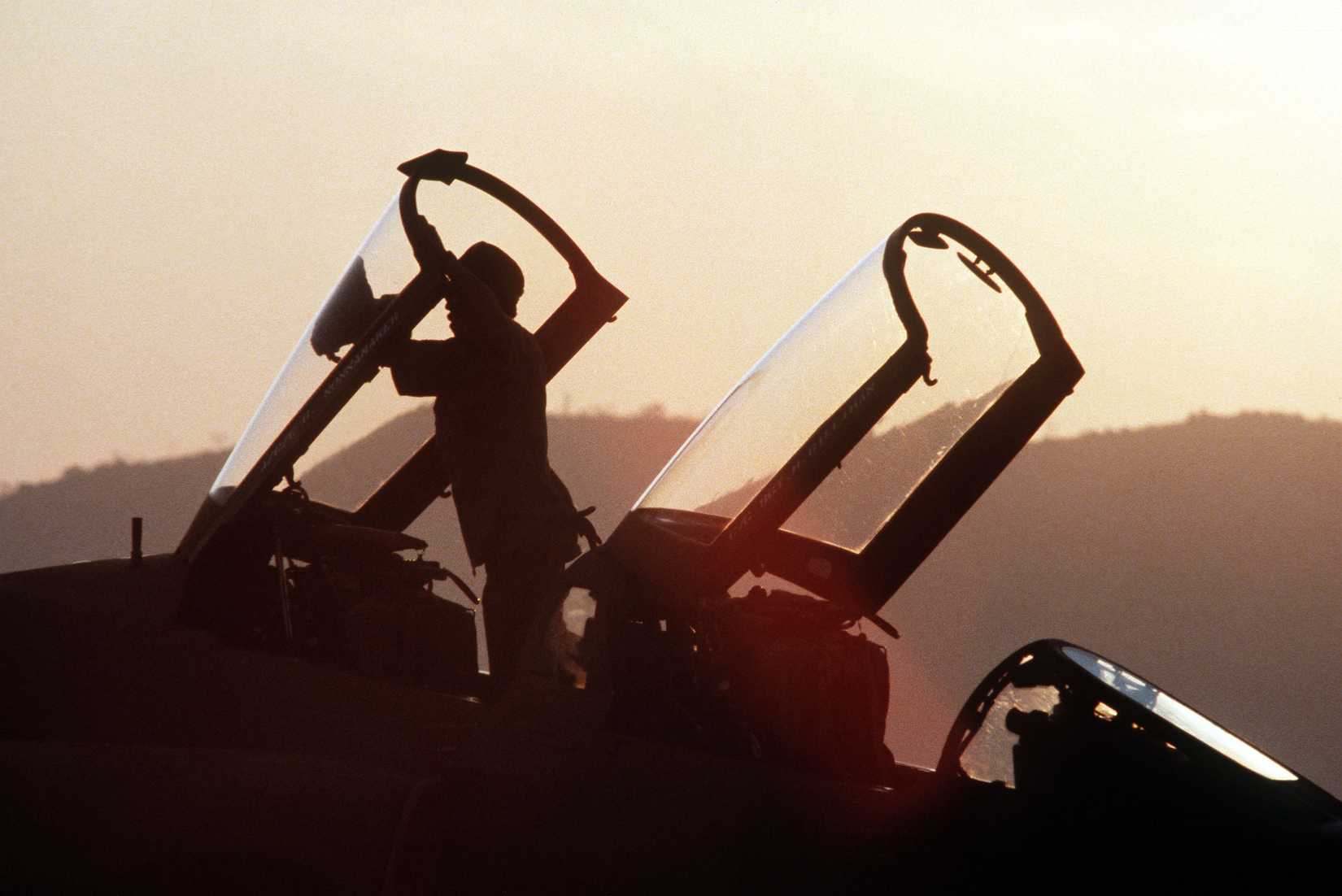 A ground crewman cleans the canopy of a 3rd Tactical Fighter Squadron F-4 Phantom II aircraft.