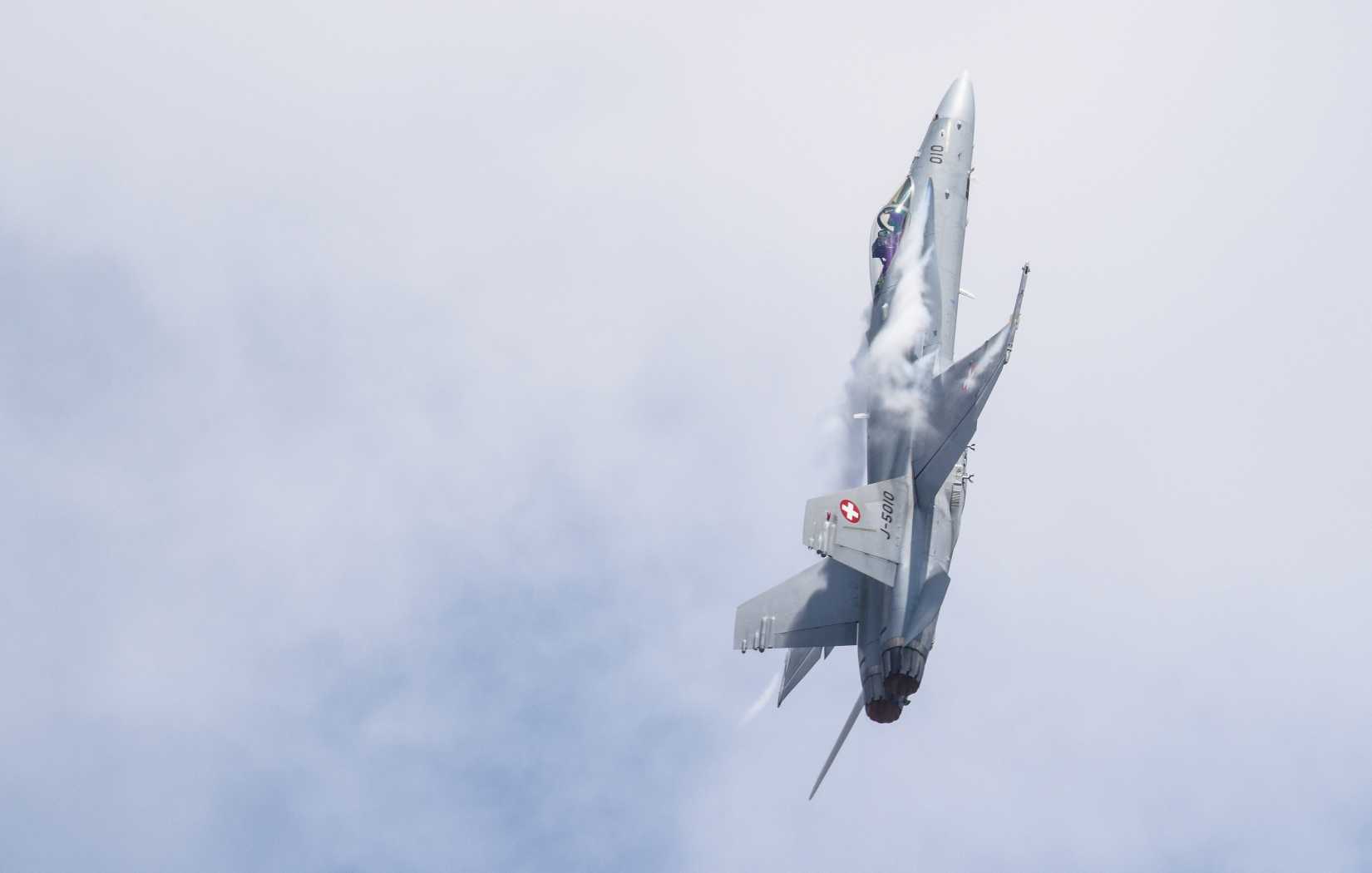 A pilot from the Swiss Air Force demonstrates the flight capabilities of a FA-18C Hornet during the 2018 Royal International Air Tattoo at RAF Fairford, United Kingdom