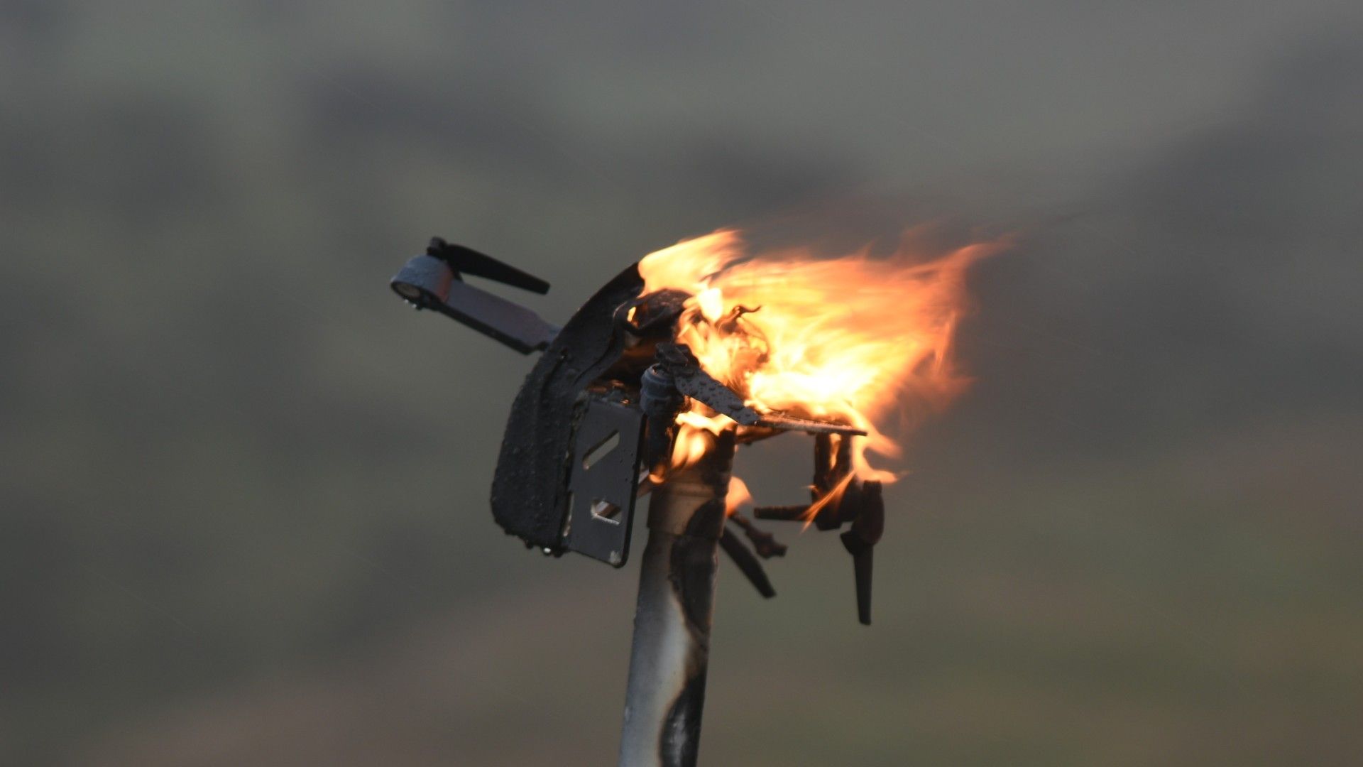 A quadcopter burns after being engaged by Aurelius Systems’ laser weapon system at the Naval Postgraduate School’s (NPS).