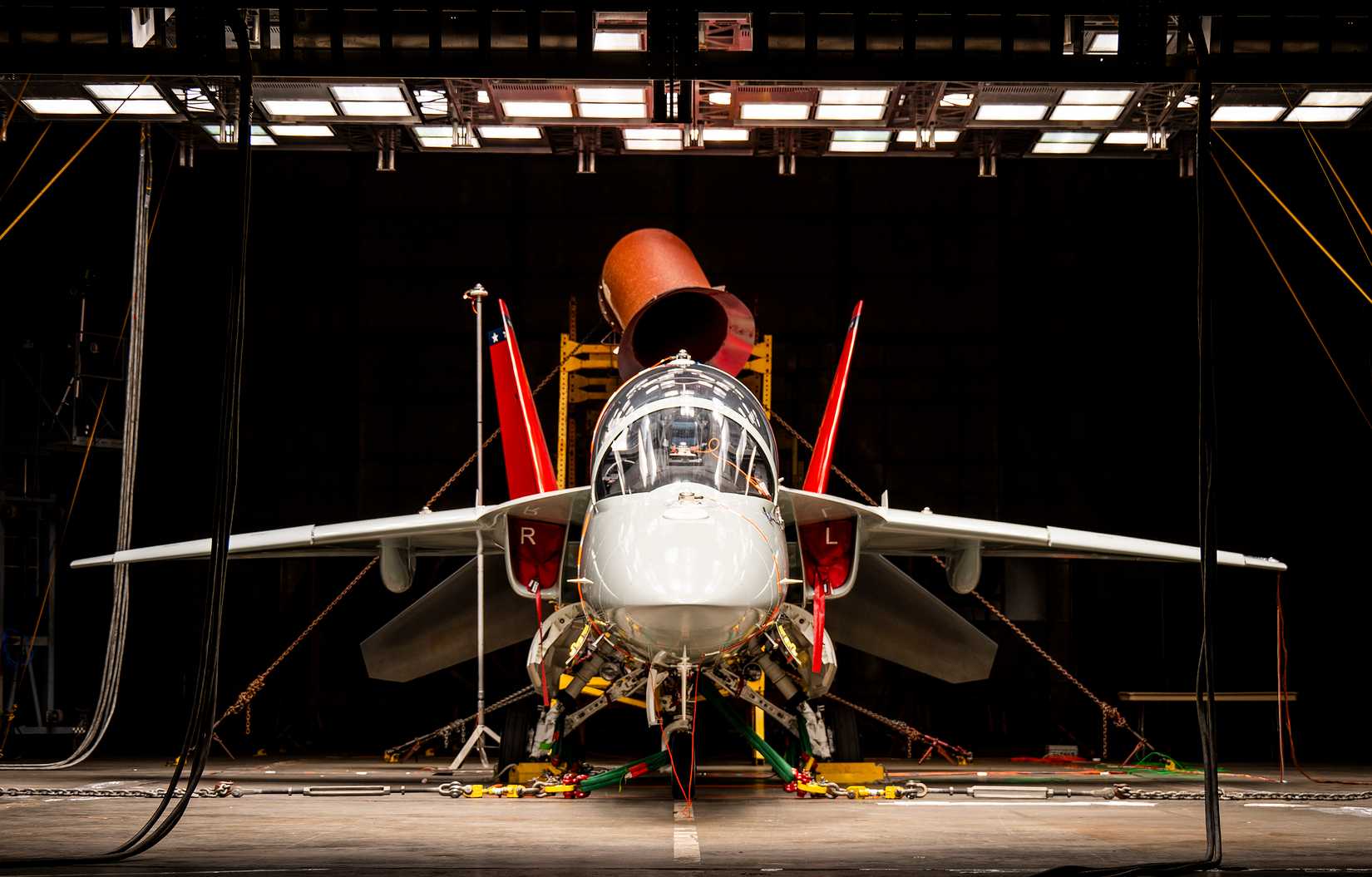 A T-7A Red Hawk sits under bright lights used to create heat in the McKinley Climatic Lab at Eglin Air Force Base, Florida, June 16
