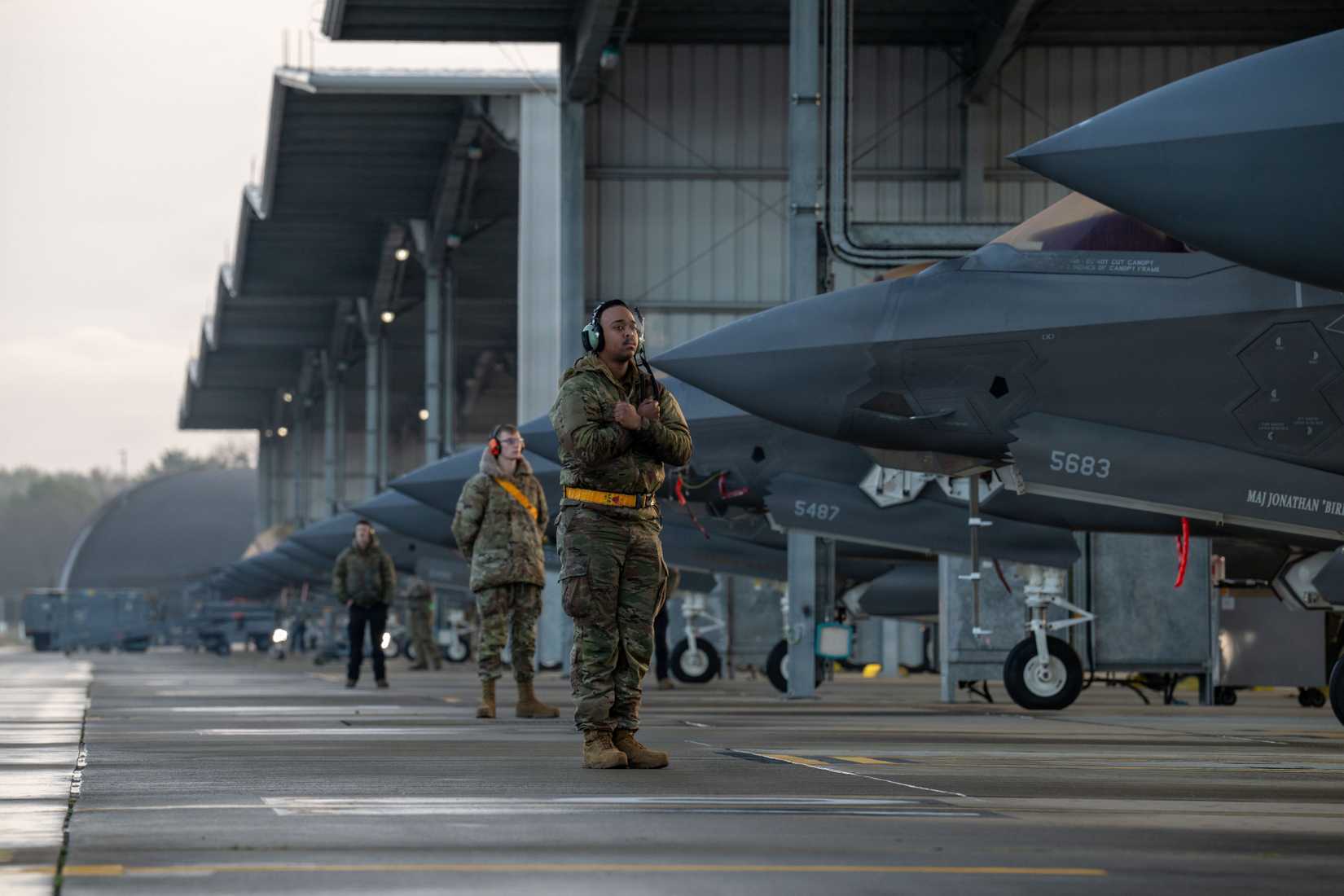 Air Force Airman 1st Class Marcus Johnson, 493rd Fighter Generation Squadron crew chief, prepares to marshal an F-35A Lightning II aircraft at RAF Lakenheath.