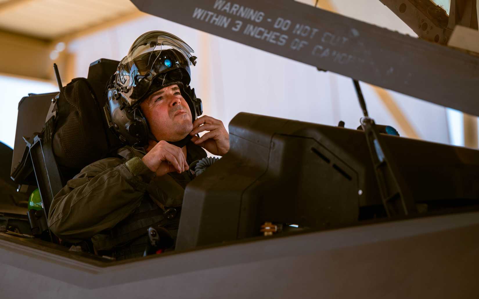 Air Force Col. Jay Spohn, 187th Fighter Wing vice commander, adjusts his helmet strap before his F-35 Lightning II flight.