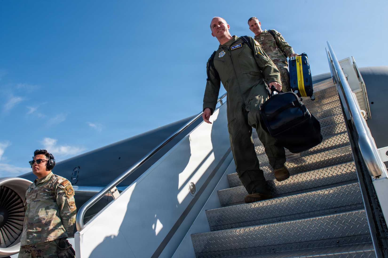 Air Force Col. Shroyer,  and Col. Travis Bohanan disembark a newly acquired KC-46A