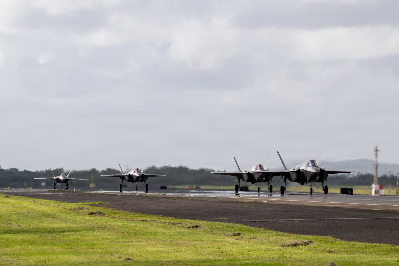 Air Force F-35 Lightning IIs and F-22 Raptors taxi from Joint Base Pearl Harbor-Hickam, Hawaii