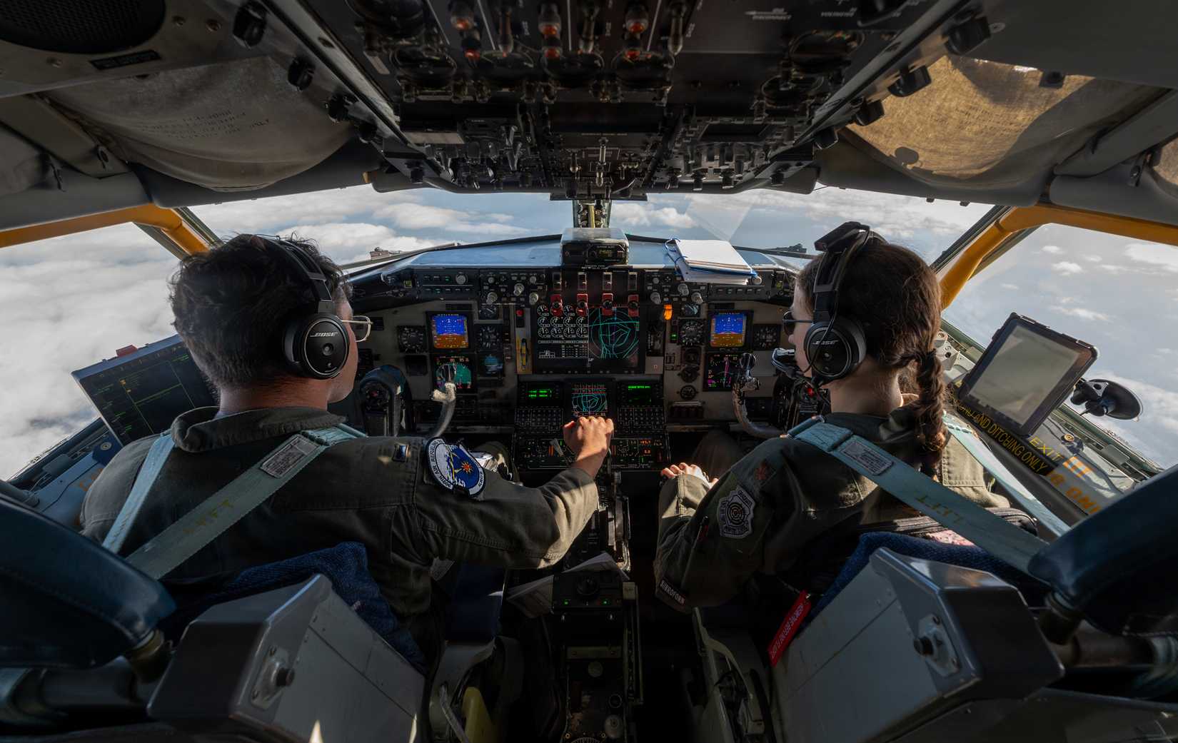 Air Force Maj. Caroline Bates, 909th Air Refueling Squadron instructor pilot, and 1st Lt. Ghamanpreet Ahluwalia, fly a KC-135 over the Pacific Ocean.