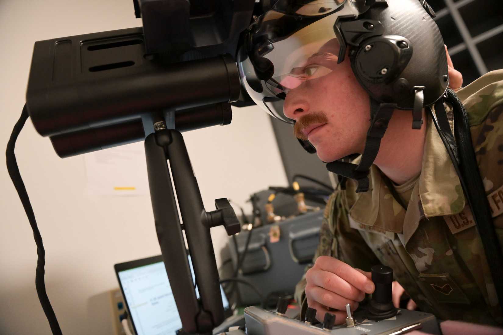 Air Force Senior Airman Jake Sprindis calibrates the optical alignment for a helmet mounted display
