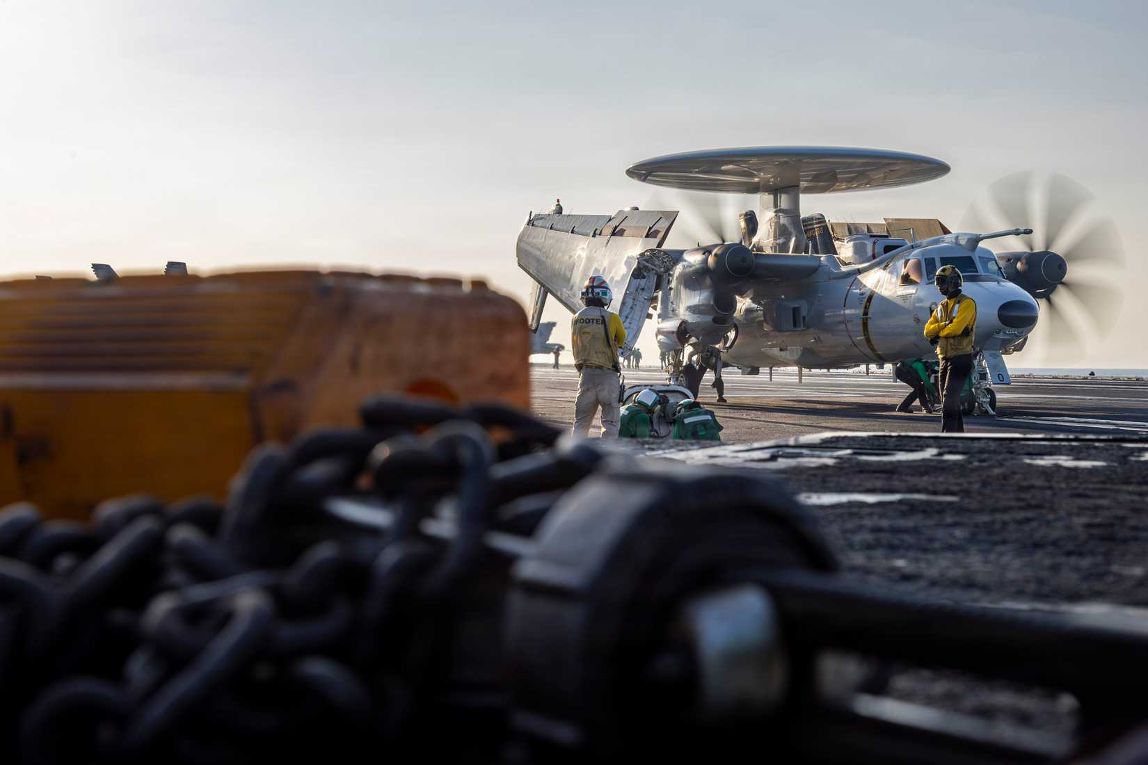 An E-2D Hawkeye, attached to Airborne Command and Control Squadron (VAW) 117, prepares to launch from the flight deck of a Nimitz-class aircraft carrier.