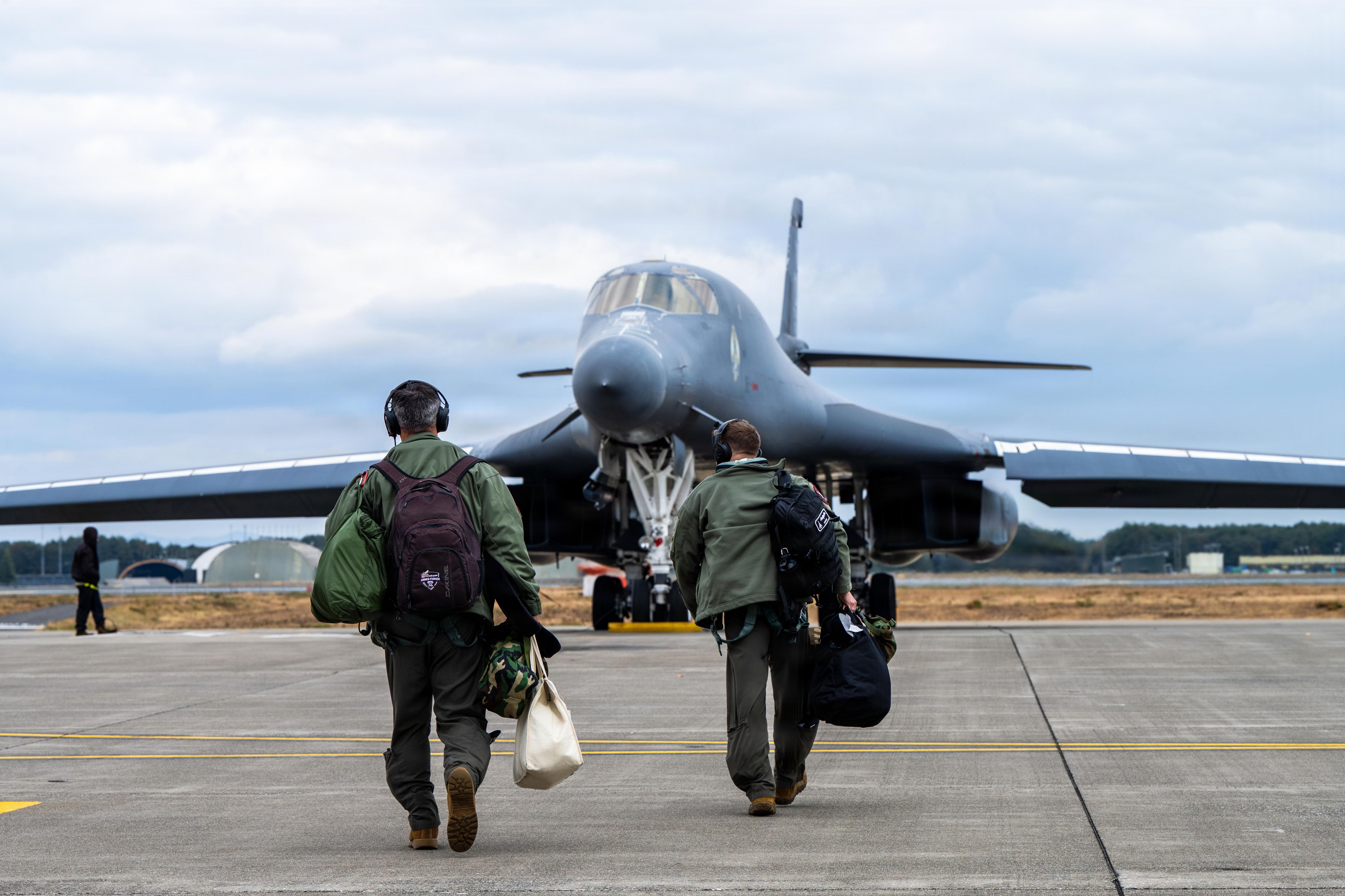 U.S. Air Force B-1B pilots walking toward a B-1B Lancer bomber.
