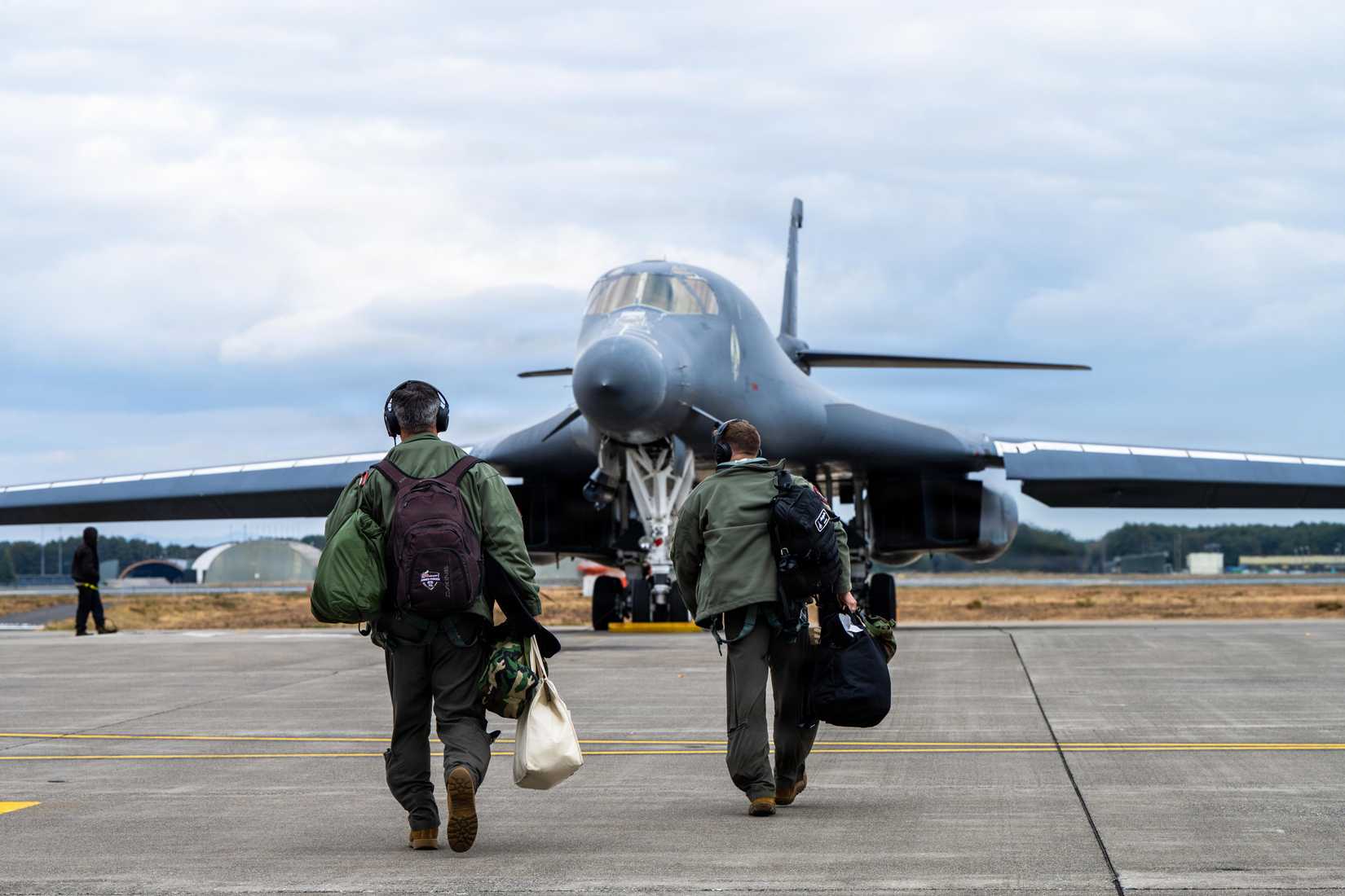 ir Force Capt. Nicholas Adams, 9th Expeditionary Bomb Squadron pilot, left, and Capt. Kyle Desautels, 9th EBS pilot, walk towards a B-1B Lancer.