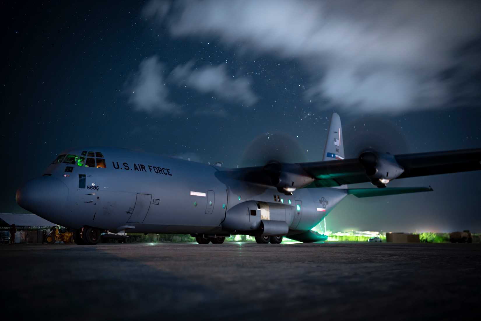 service members unload cargo from a C-130J Hercules assigned to the 75th Expeditionary Airlift Squadron (75th EAS) in East Africa.