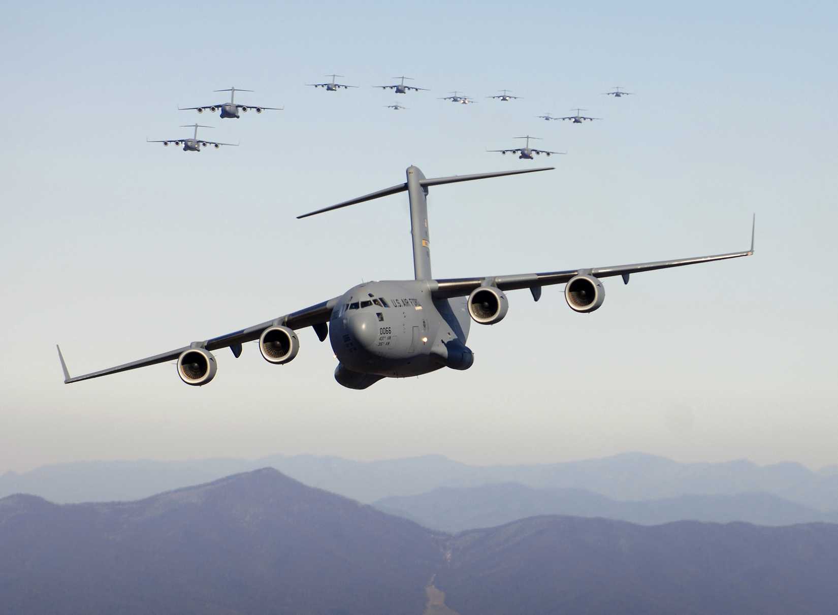 Seventeen C-17 Globemaster III aircraft fly over the Blue Ridge Mountains in Virginia during low level tactical training.