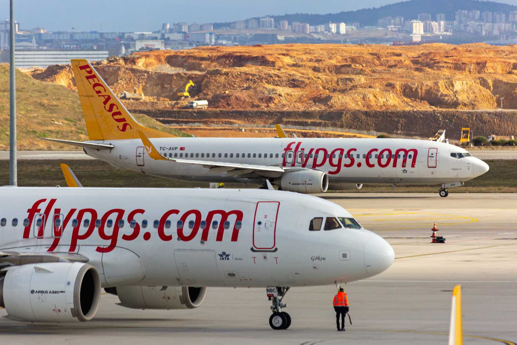 Airbus a320 and Boeing 737 planes on the airport taxiway waiting for take off. Side View.
