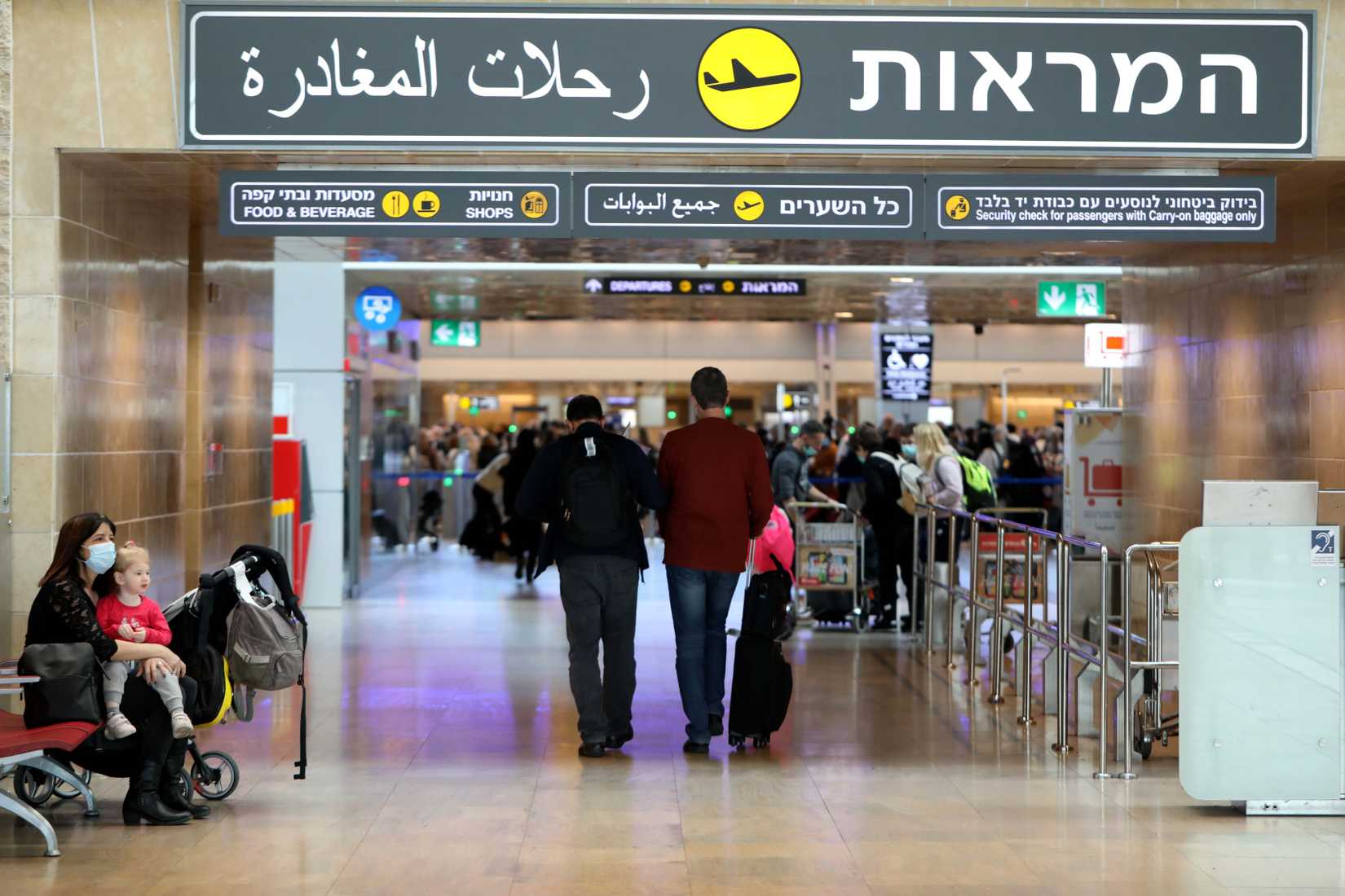 Travelers wait at the departure nall at Ben Gurion International Airport near Tel Aviv, Israel,