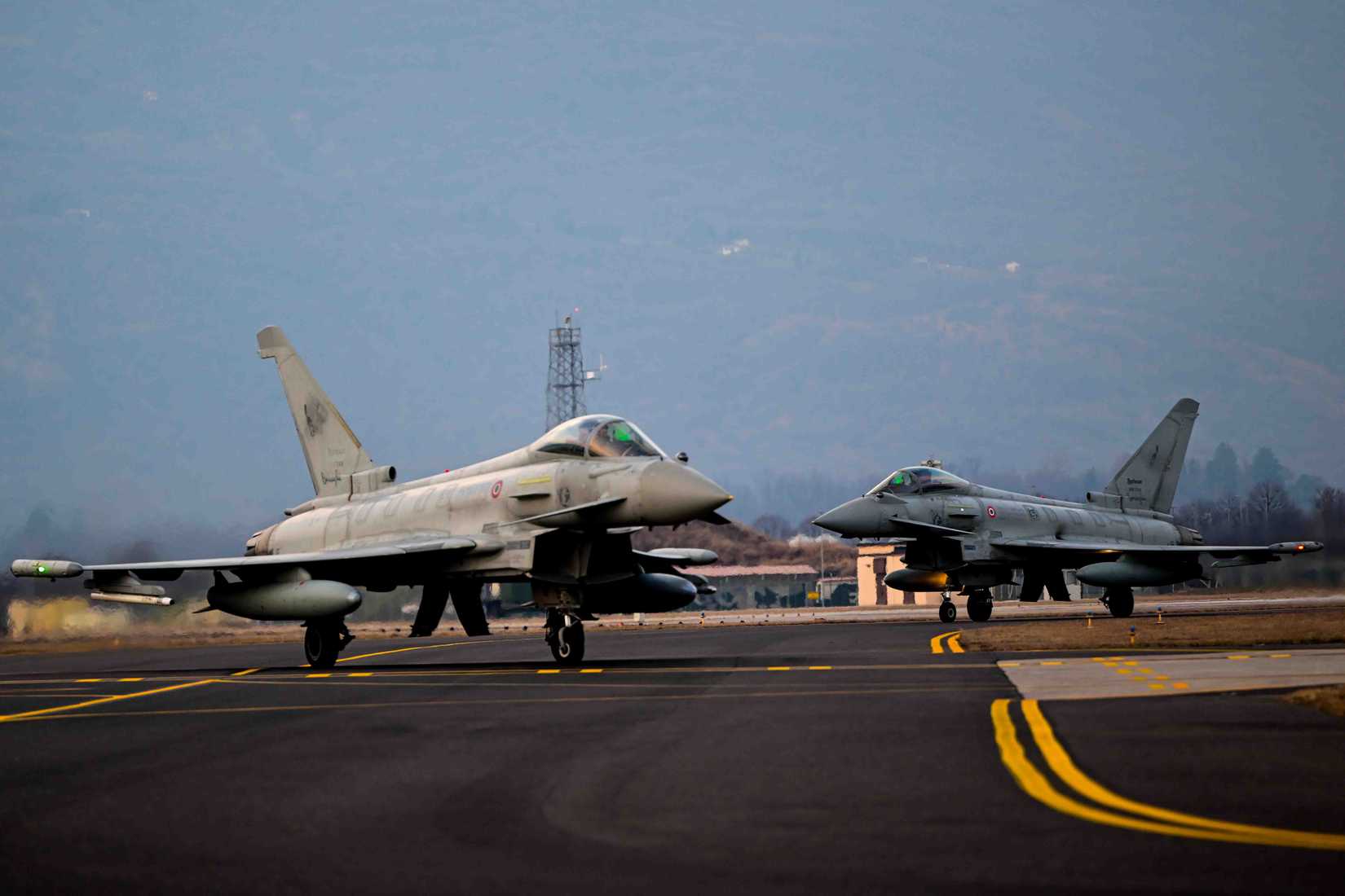 Two Italian air force Eurofighter Typhoons assigned to the 51st Wing at Istrana Air Base, Italy, taxi.