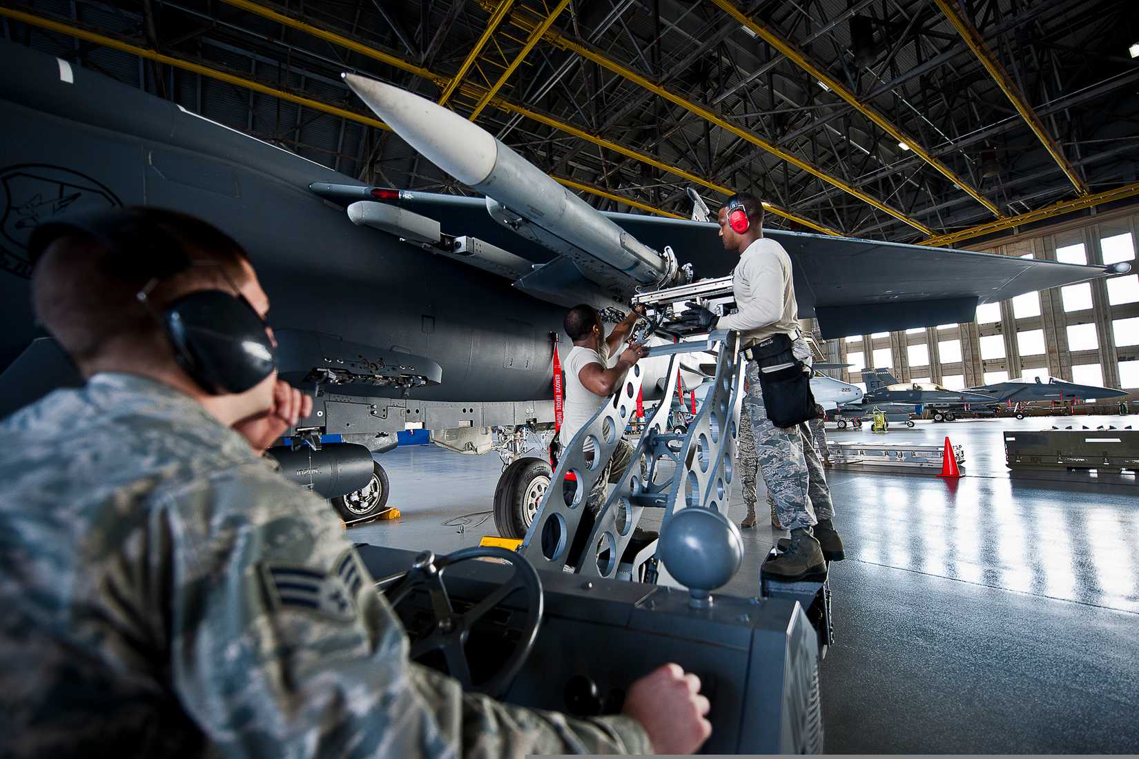  U.S. Airmen with the 96th Aircraft Maintenance Squadron connect an AIM-120 Advanced Medium-Range Air-to-Air Missile to an F-15 Eagle aircraft during a weapons load crew competition at Eglin Air Force Base, Fla., Feb. 14, 2014.