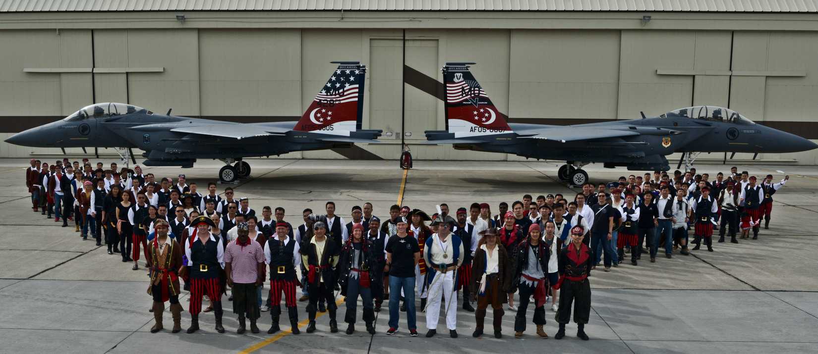 Airmen and family members from the U.S. and Republic of Singapore Air Forces pose for a group photo at the Peace Carvin V celebration at Mountain Home Air Force Base, Idaho, May 16, 2014. 