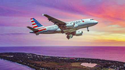 American Airlines Airbus A319 flying over an island