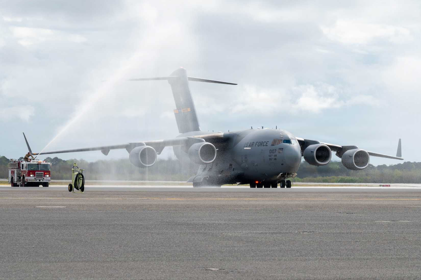 A C-17 Globemaster III is sprayed by firetrucks upon its return to Joint Base Charleston, South Carolina.