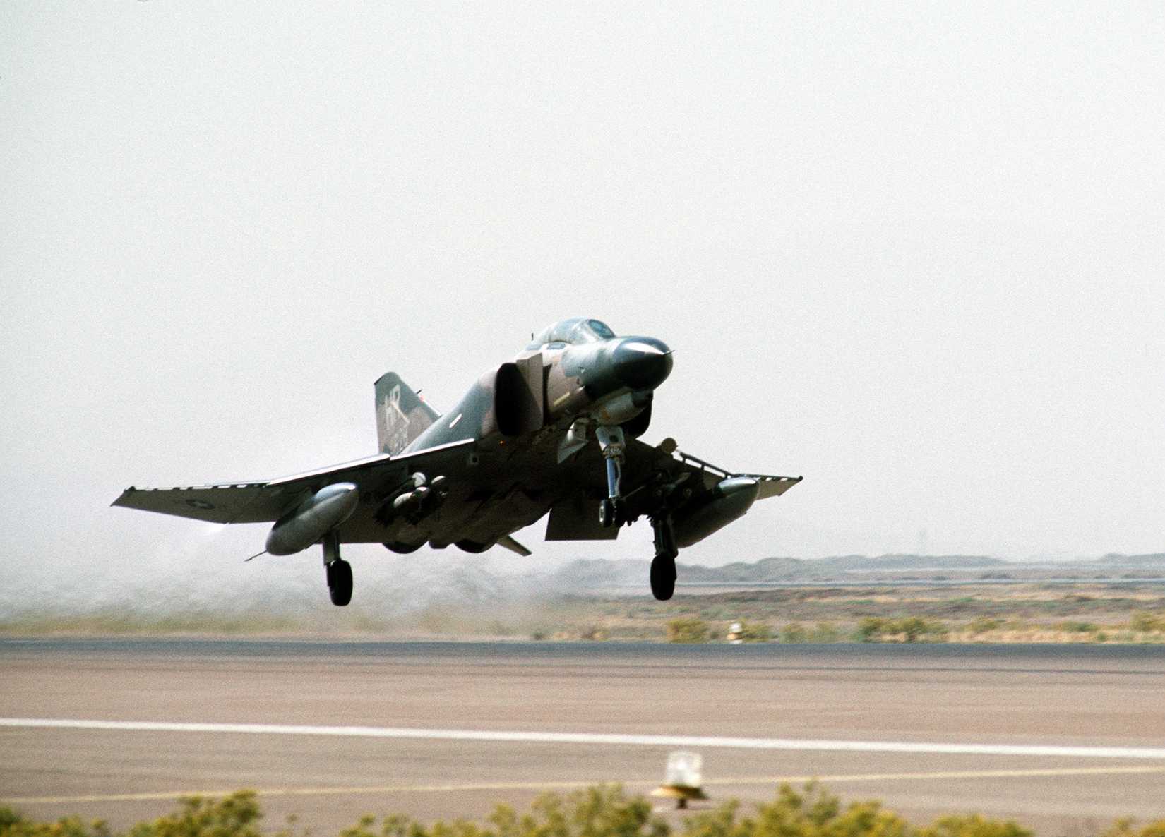 A right front view of an F-4 Phantom II aircraft taking off from Shiraz Air Base
