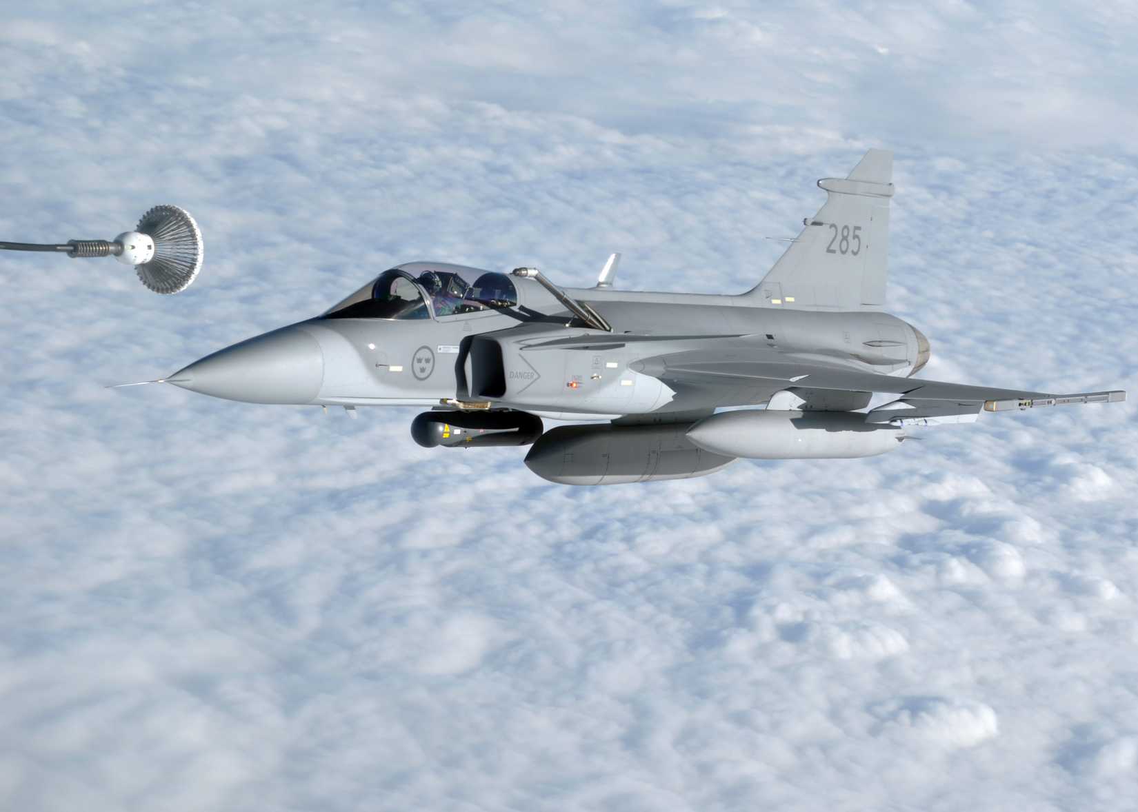 A Swedish JAS-39 Gripen prepares to take on fuel from a U.S. Air Force KC-135R Stratotanker.