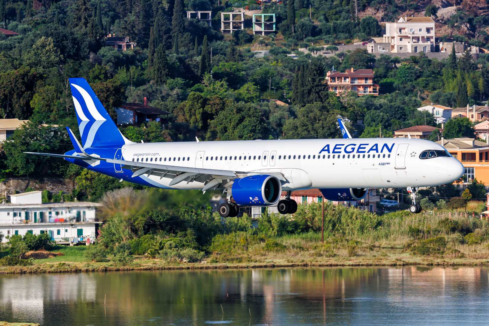 Aegean Airlines Airbus A320neo coming in to land, flying low over a lake