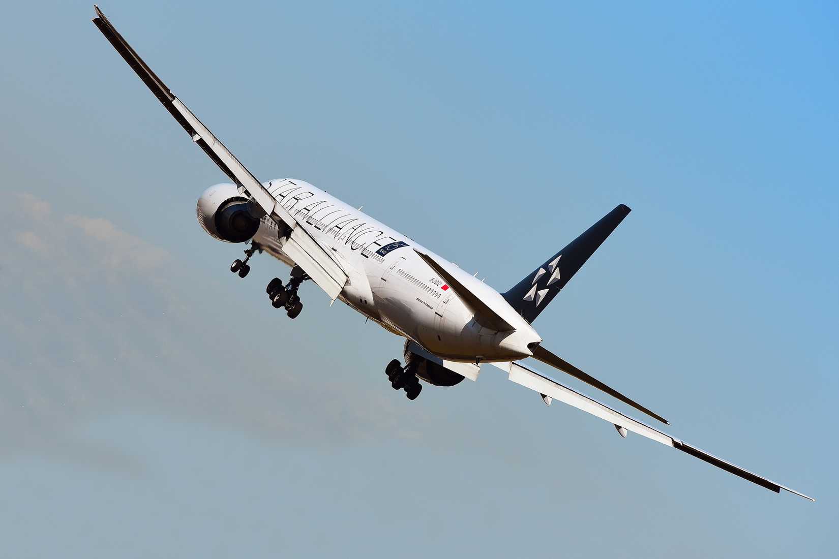 Air China Boeing 777-300ER over airport in Frankfurt, Germany.