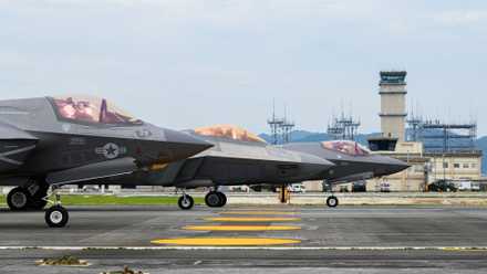 Air Force 354th Air Expeditionary Wing F-22As and Marine Aircraft Group 12 F-35Bs perform an Elephant Walk together.