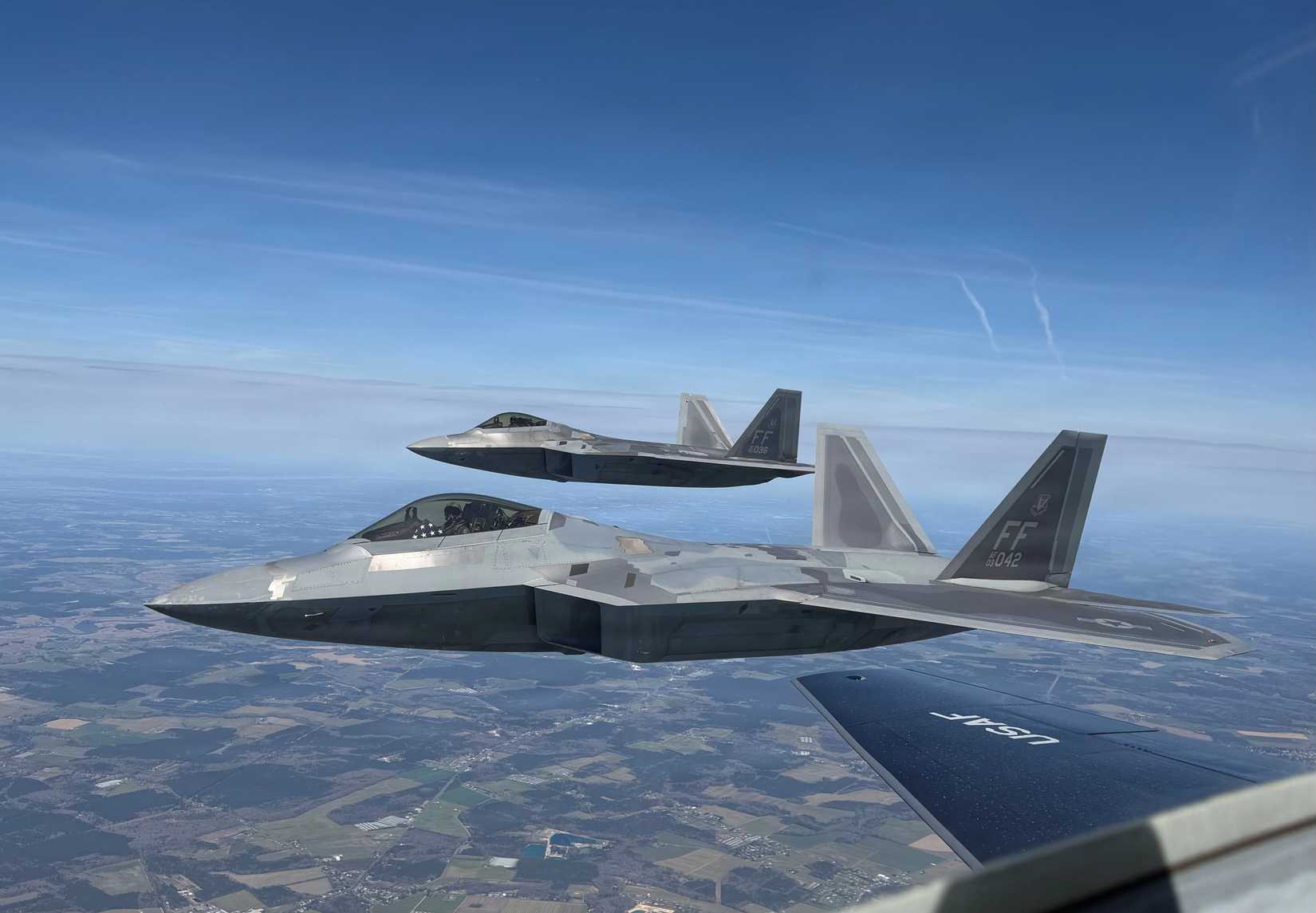Air Force Chief of Staff General Ken Wilsbach flies an F-22 while displaying the American flag.