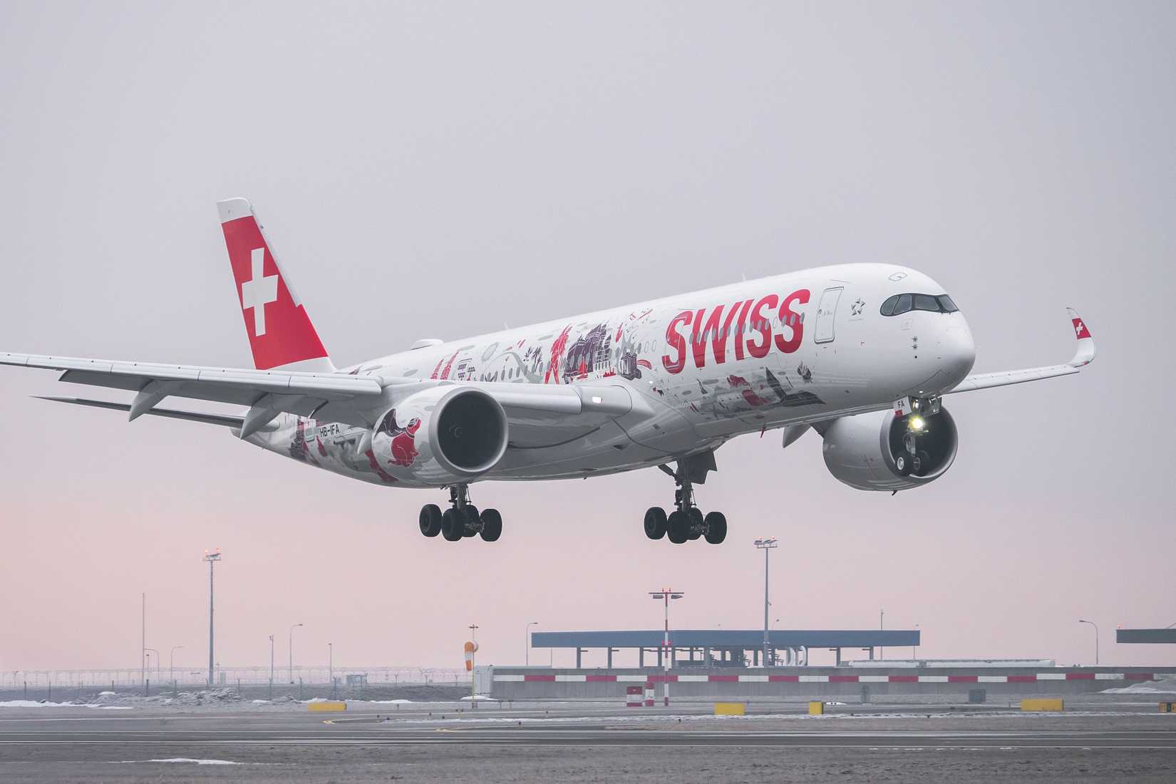 Airbus A350-900 (HB-IFA) of SWISS International Air Lines lands at a snowy Prague airport.