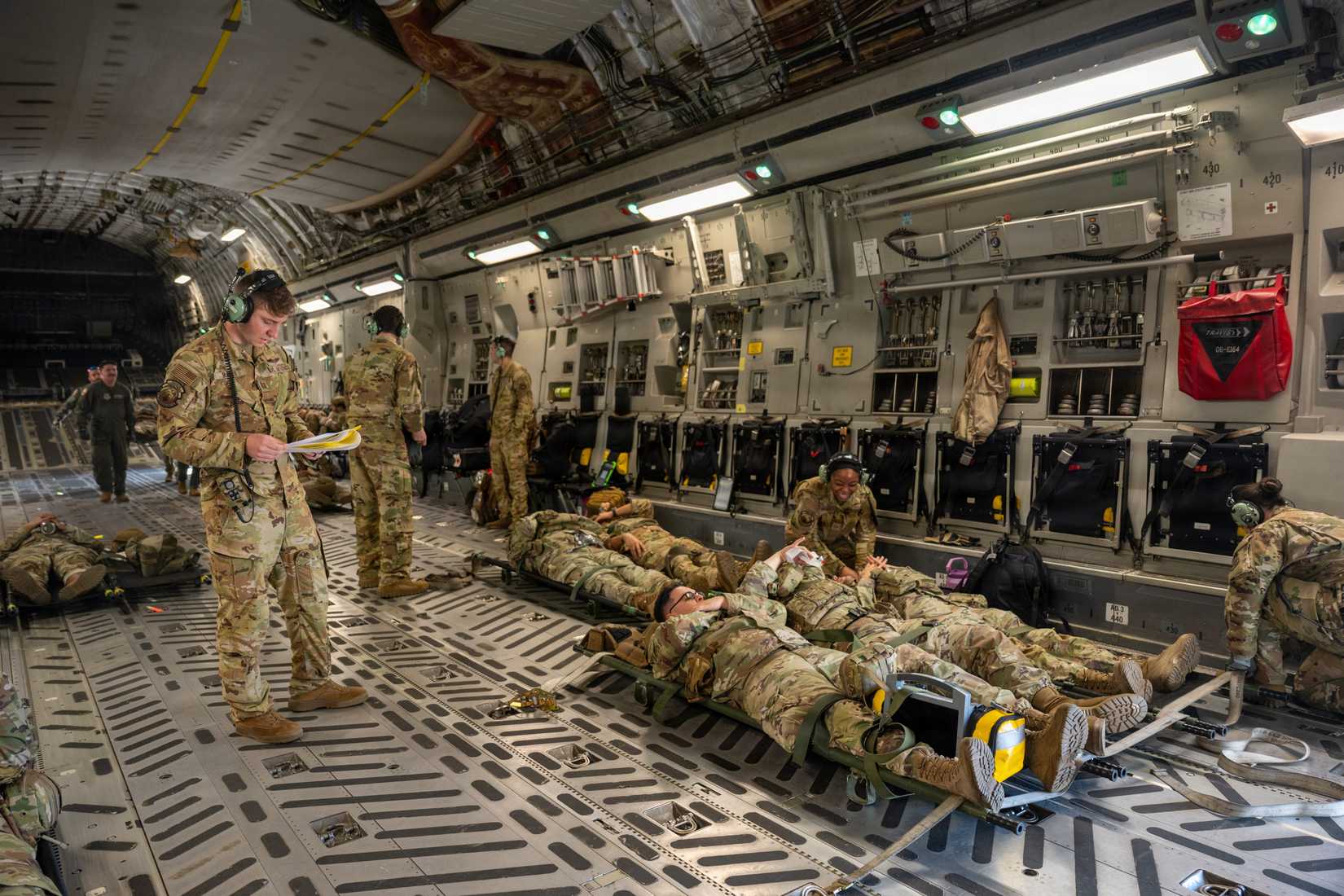 Airmen conduct in-flight patient care procedures during February Exercise 2026, aboard a C-17.