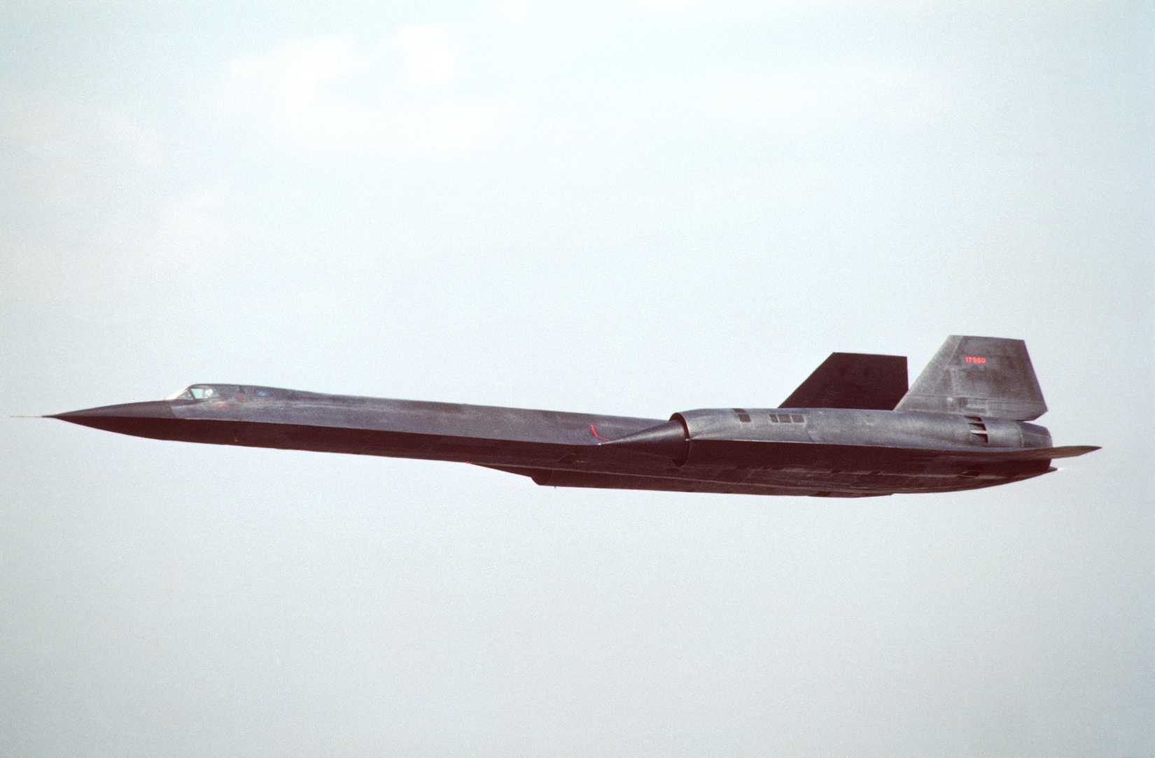 An air-to-air left side view of an SR-71 strategic reconnaissance aircraft.