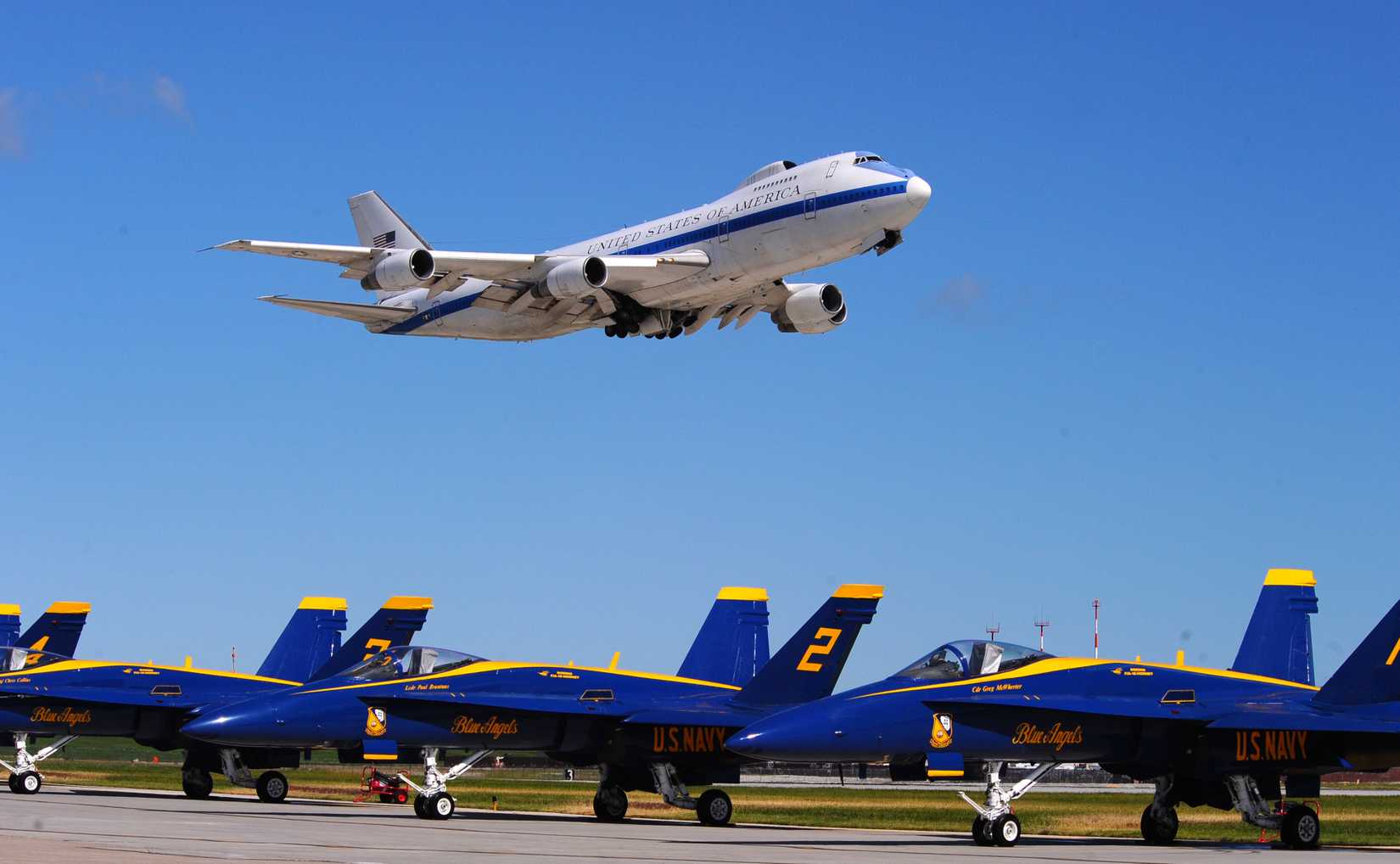 An E-4B Nightwatch aircraft flys over the U.S. Navy Blue Angels F-18s during the 2009 Defenders of Freedom Open House and Air Show.