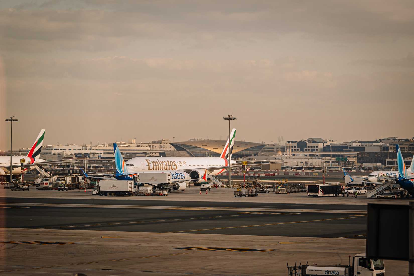 An Emirates Boeing 777 parked on the tarmac.