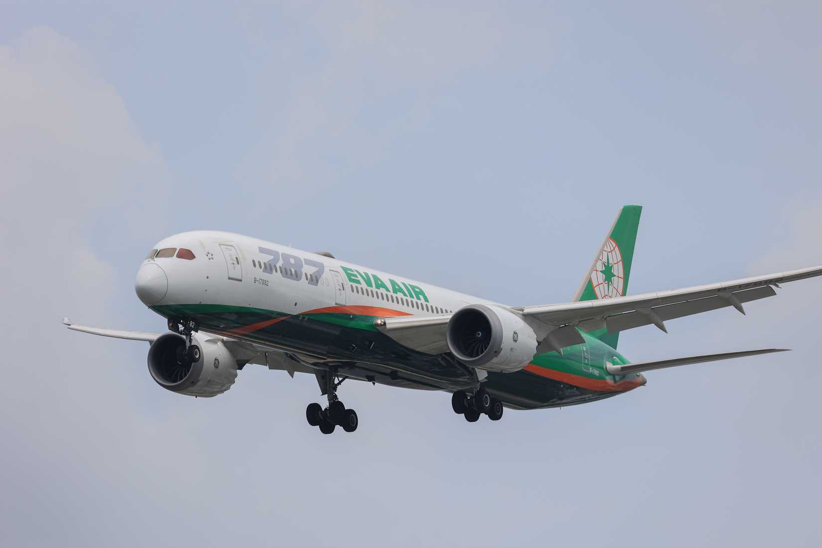 An EVA Air Boeing 787-9 Dreamliner featuring a large logo approaches Fukuoka Airport for landing.