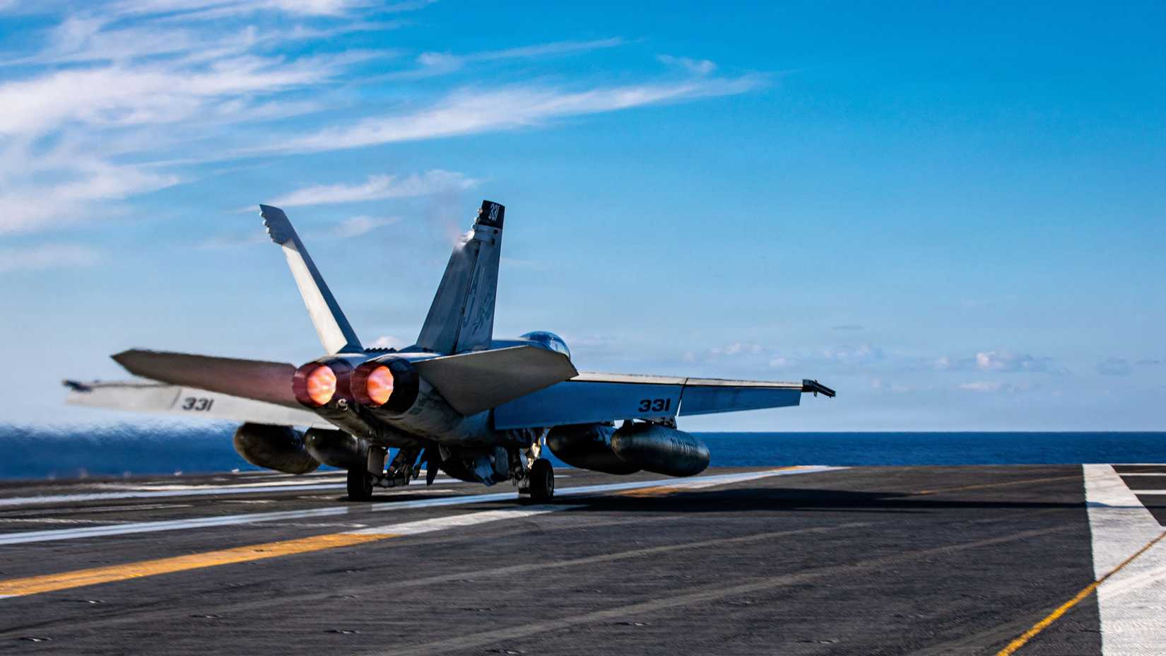 An FA-18E Super Hornet aircraft, attached to Strike Fighter Squadron 31, launches from the flight deck.