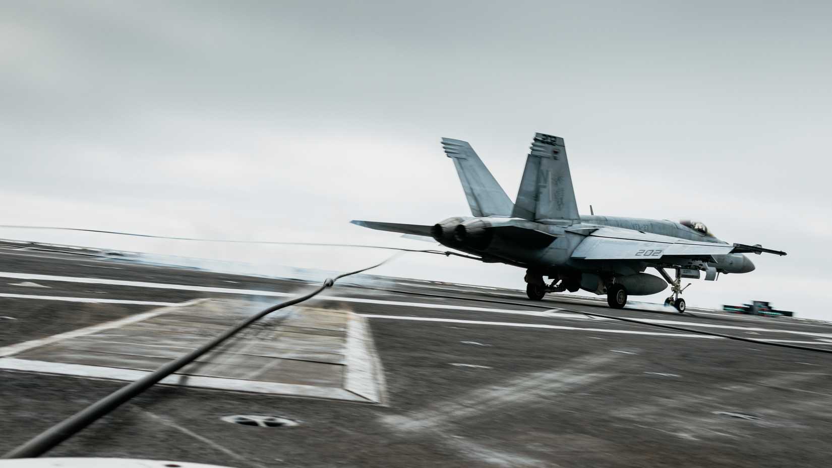 An FA-18E Super Hornet, attached to the Royal Maces of Strike Fighter Squadron (VFA) 27, lands on the flight deck.