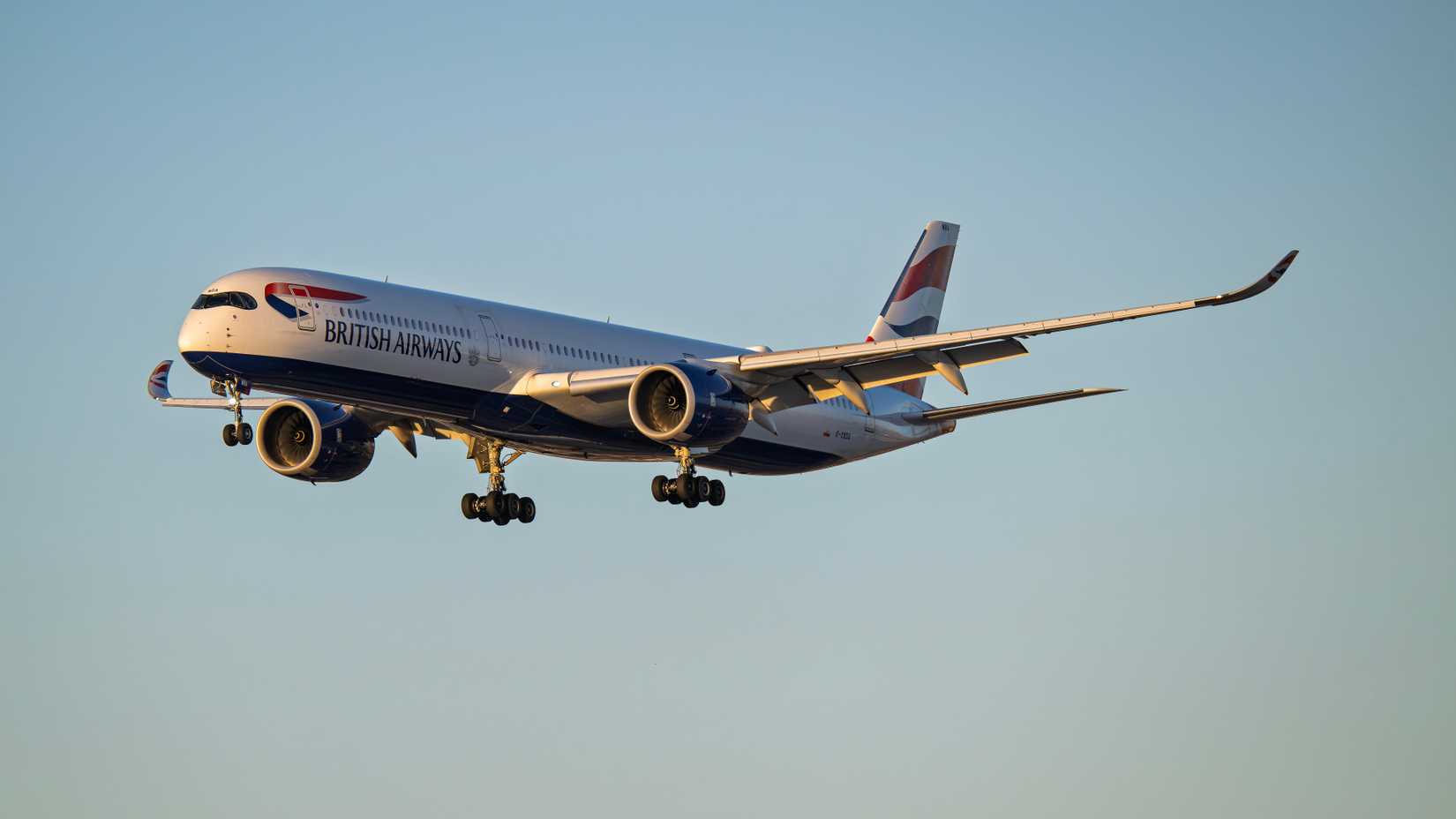 British Airways Airbus A350-1000 G-XWBA sunset arrival at Phoenix Sky Harbor Intl. Airport.