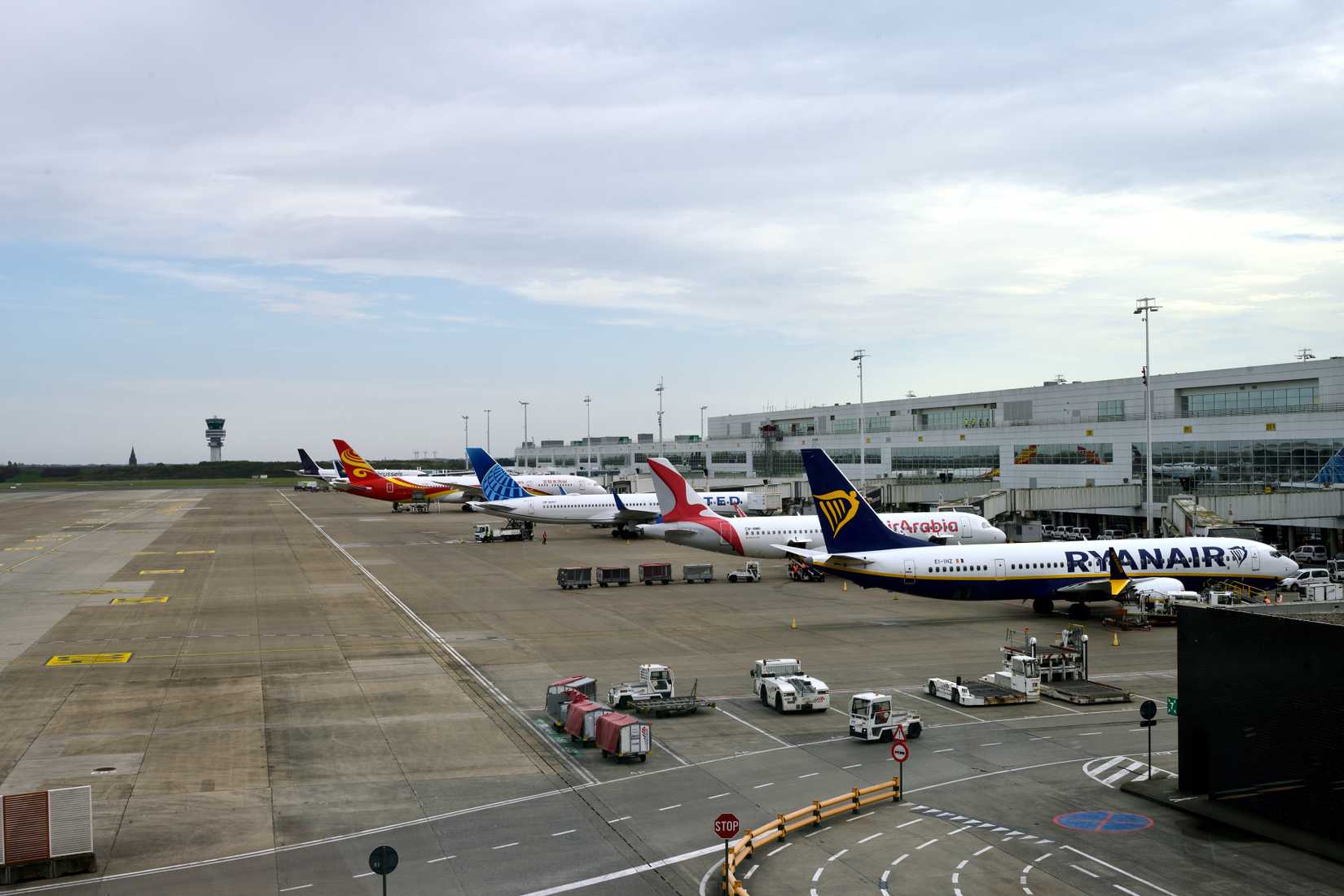 Brussels Airport terminal with aircraft from Ryanair, United, Air Arabia and more parked