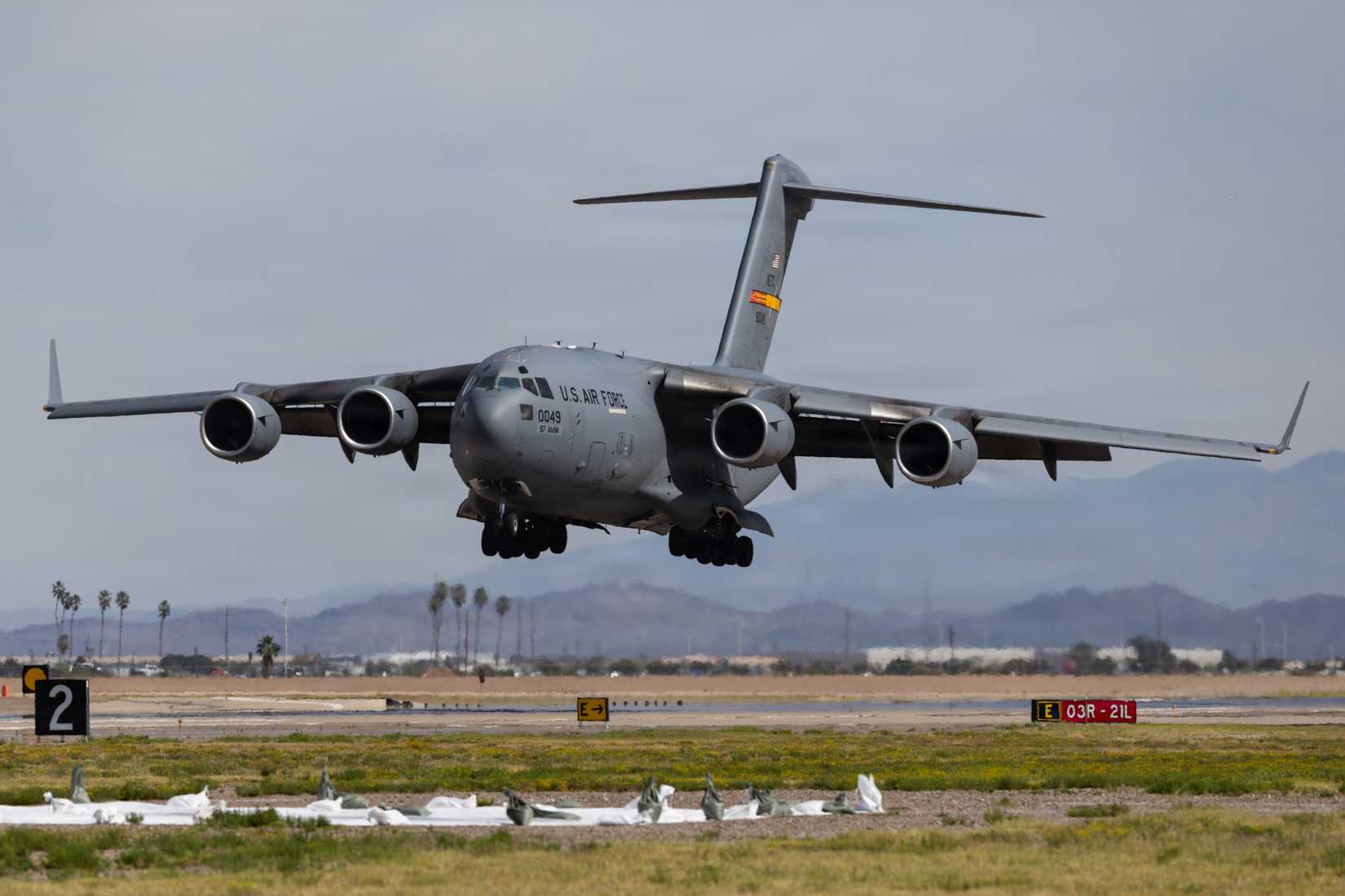Demonstrating its short runway landing capability, a C-17 Globemaster III lands during the Luke Day 2026 airshow.