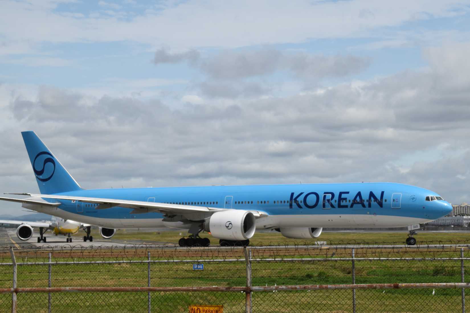 Korean Air airplane with new livery in the runway of Manila Airport. Boeing 777-300ER.