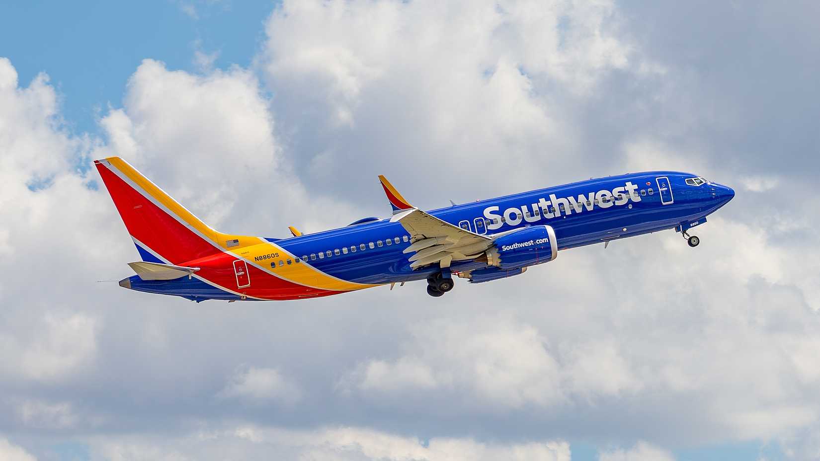 Southwest 737 MAX 8 flying across cloudy skies