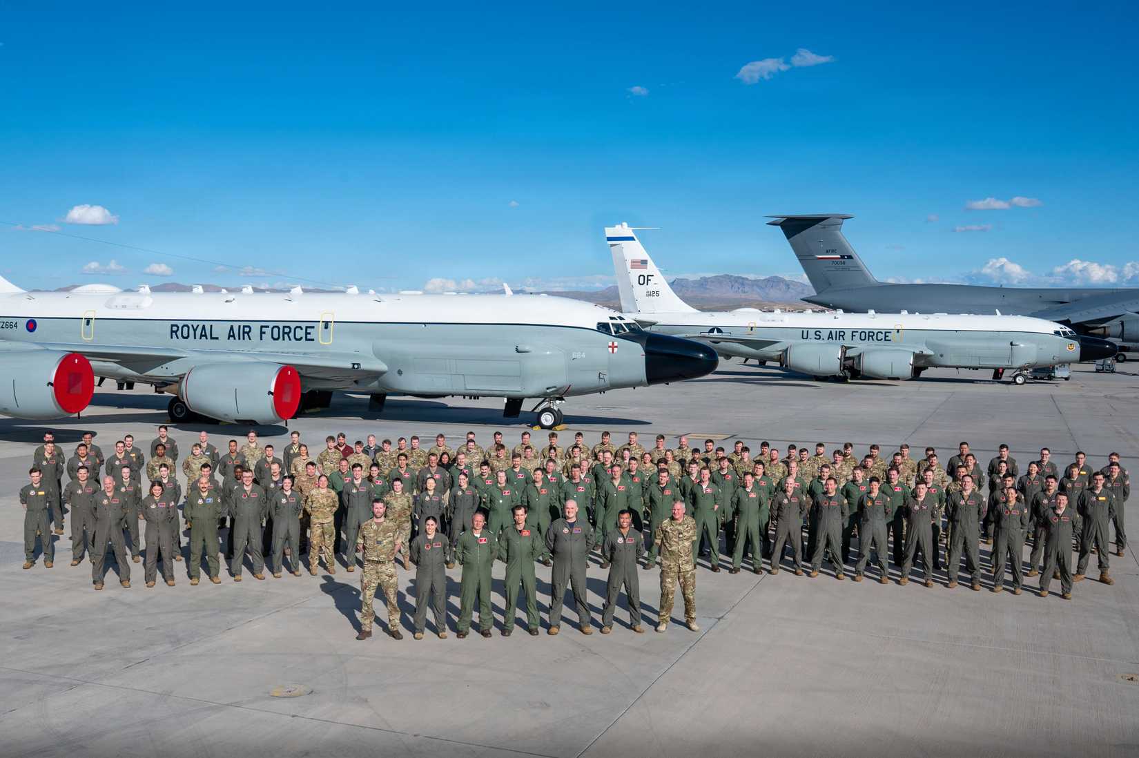 The USAF 55th Wing, and RAF No. 51 Squadron pose for a photo in front of a RAF and a USAF RC-135 Rivet Joint.