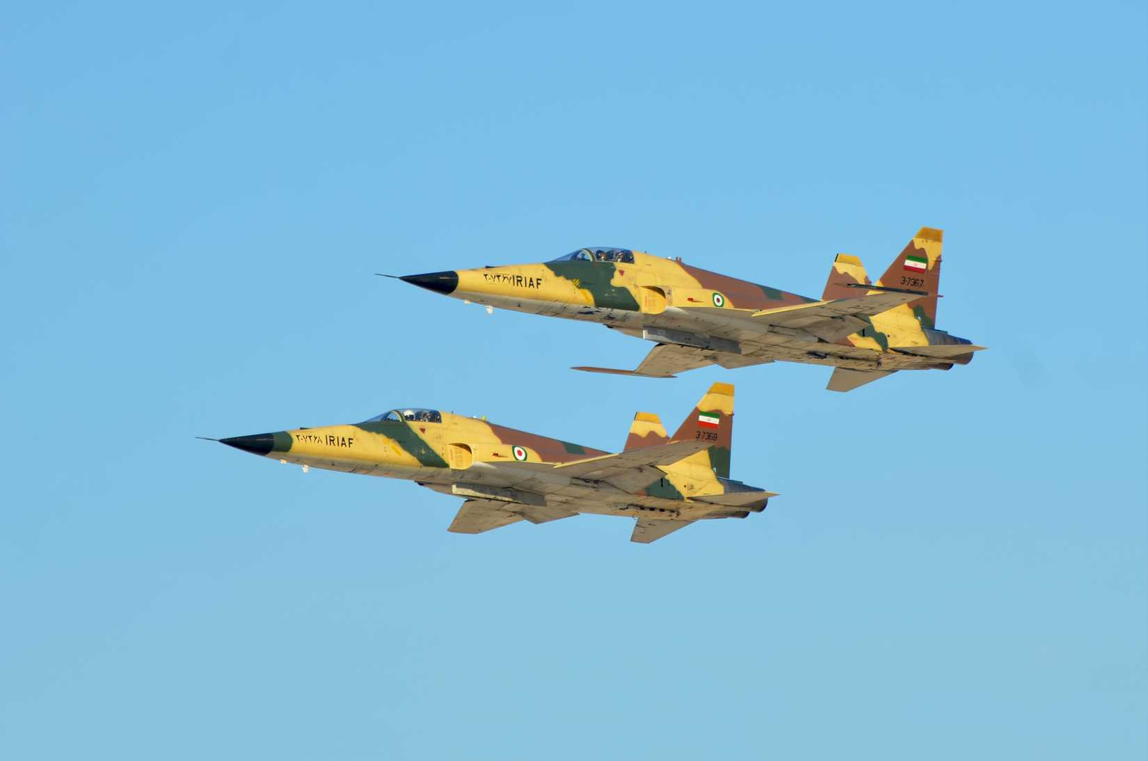 two Iranian air force F-5E Saeqeh flying in the formation during an air show.