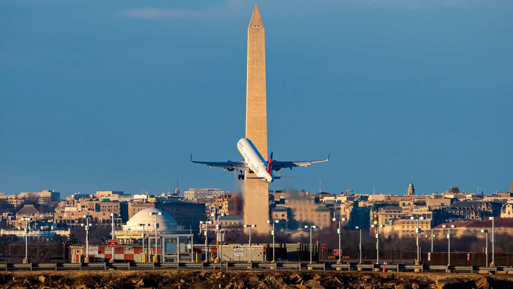 Washington, D.C.- January 22, 2021 Delta Airlines Airbus A321 takes off from Ronald Reagan National Airport with the Washington Monument in the background (1)