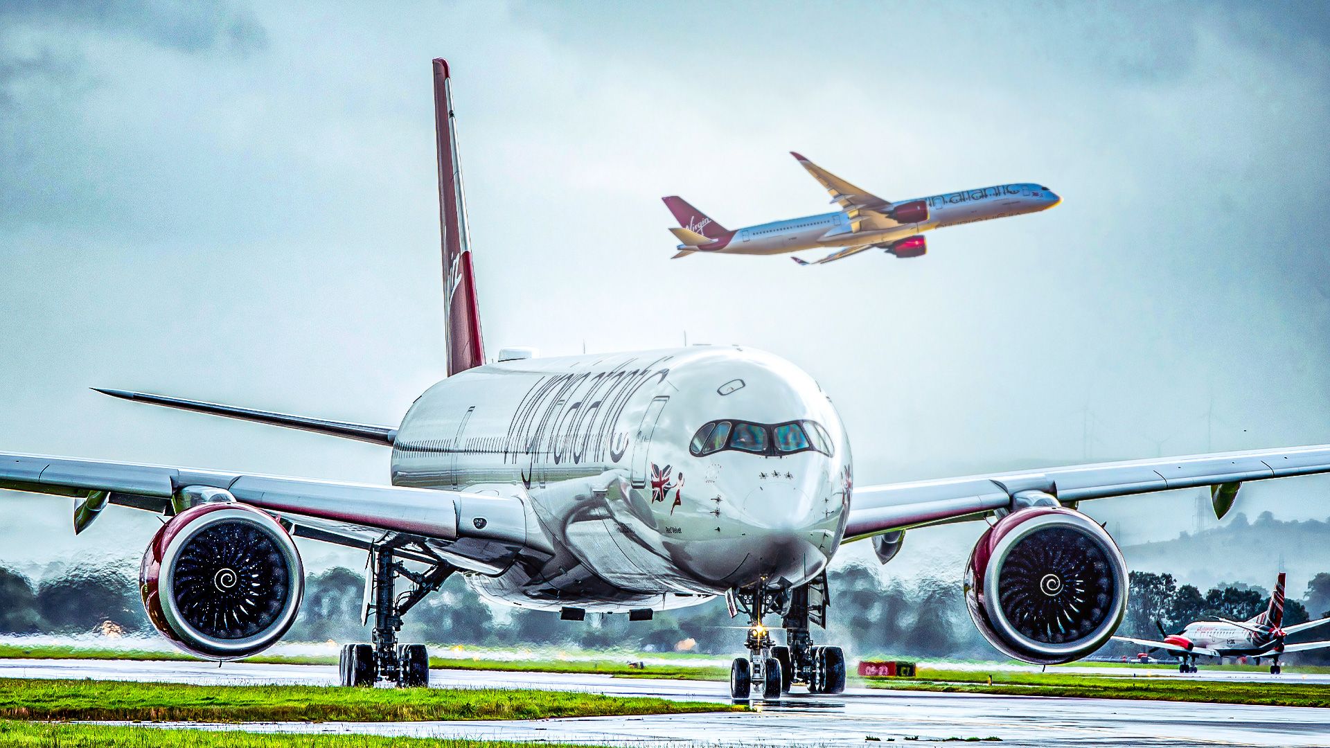 Virgin Atlantic Airbus A350 taxiing while another A350 is taking off in the background
