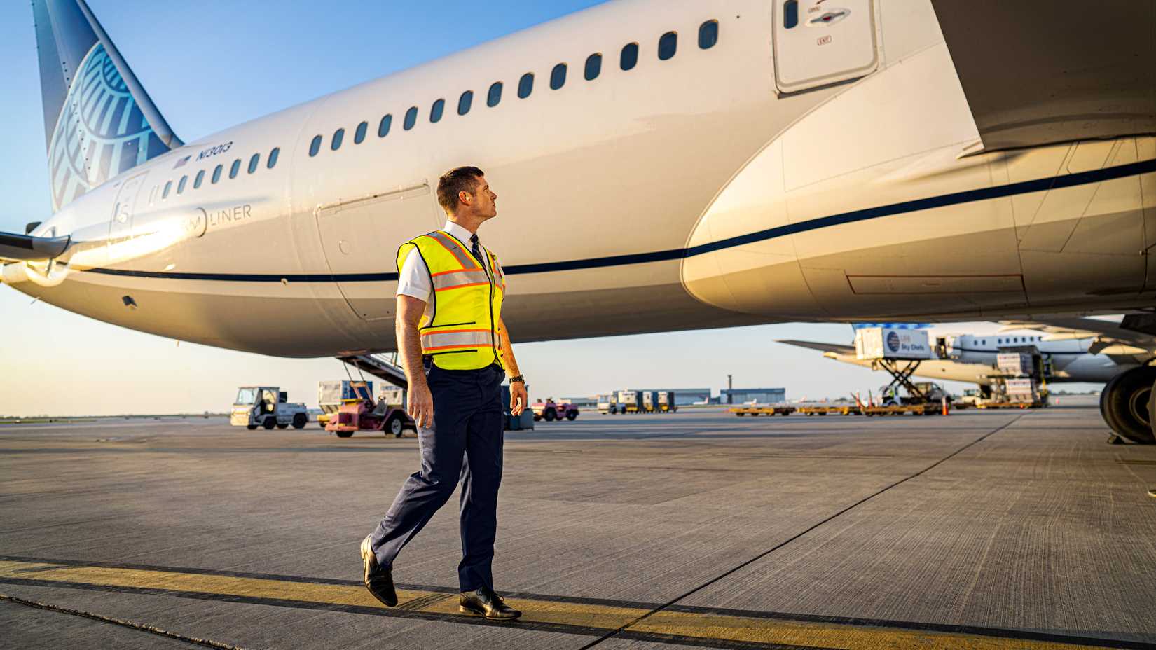 A United Airlines Pilot Walking By His Plane Custom Thumbnail