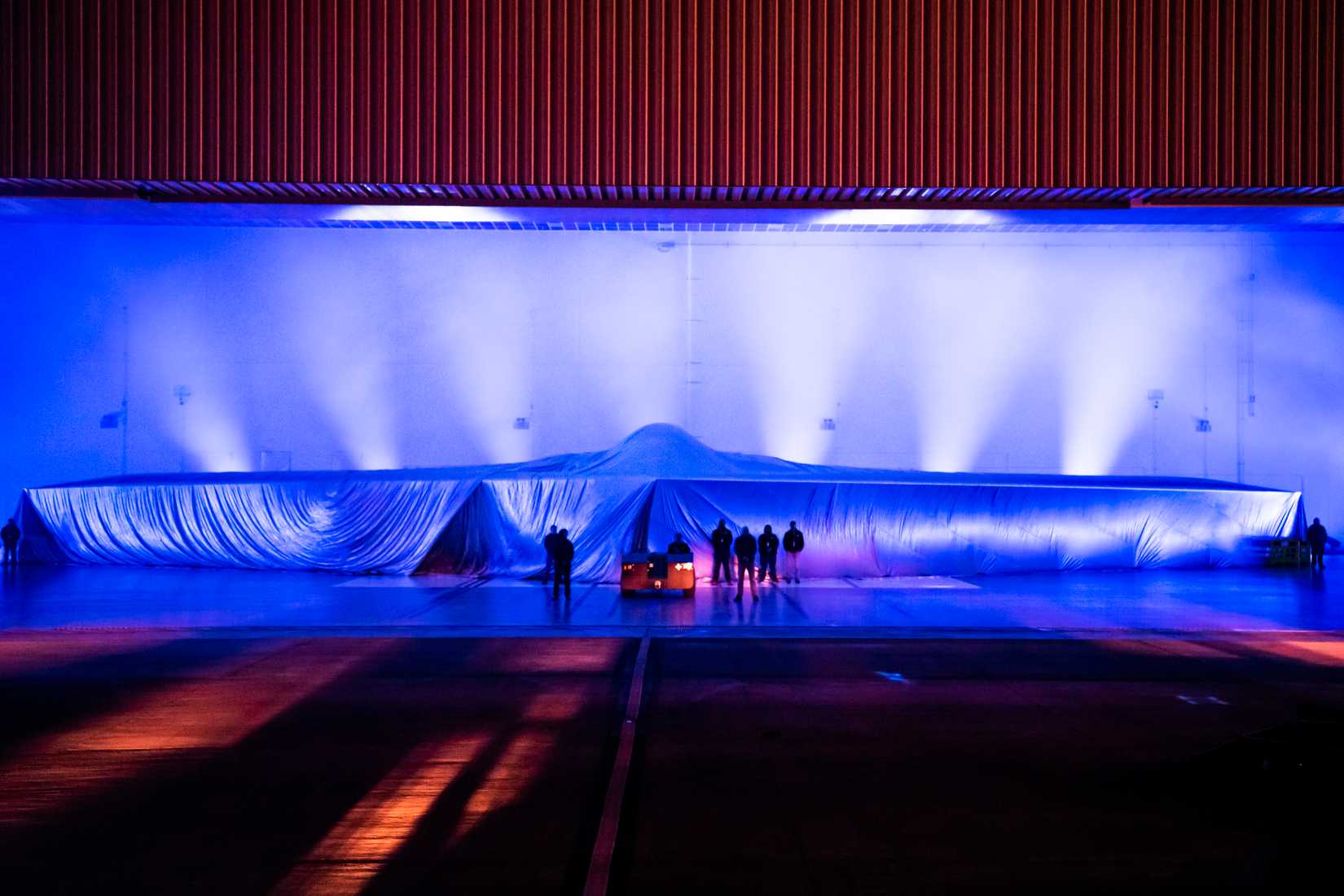 A covered Northrop Grumman B-21 Raider is displayed during a practice unveiling ceremony at Northrop Grumman’s manufacturing facility on Air Force Plant 42 in Palmdale, California, Dec. 1, 2022.