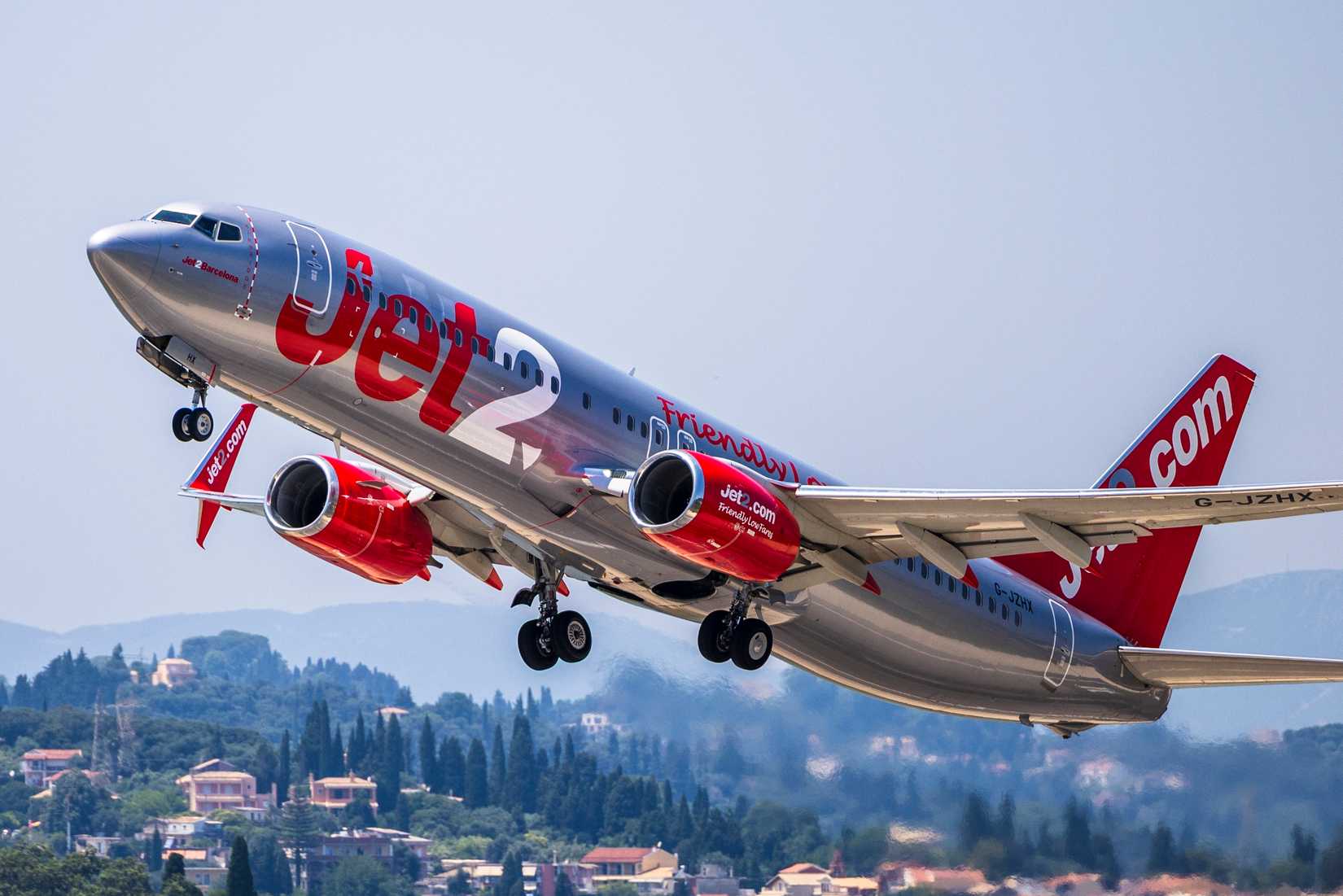 A dynamic low-angle shot of a Boeing 737-8MG operated by Jet2.com, after takeoff from Corfu International Airport (CFU), Greece.