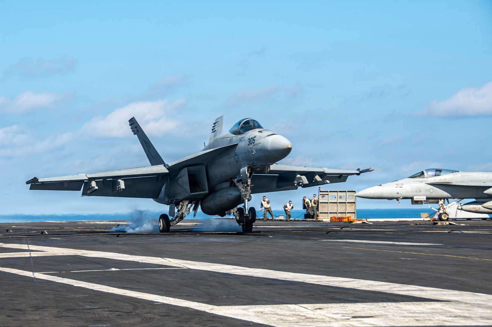 A FA-18E Super Hornet, attached to the “Kestrels” of Strike Fighter Squadron (VFA) 137, conducts a touch-and-go on the flight deck.